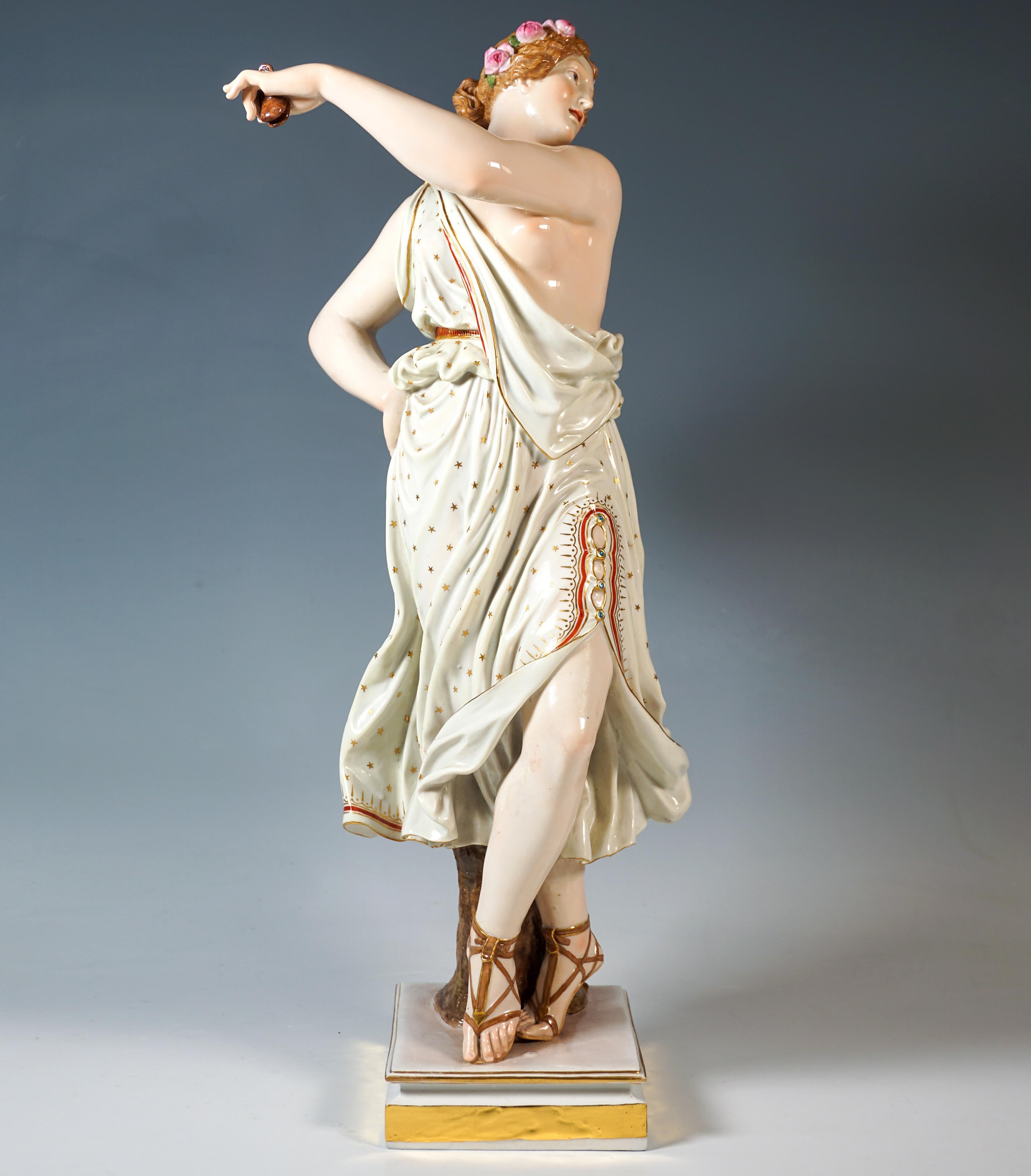 Excellent large and rare Meissen figurine from the 19th century:
Fully sculpted porcelain figurine of an antique-style young beauty standing in a dancing pose in an elaborately pleated white dress that skims her body, decorated with golden stars and