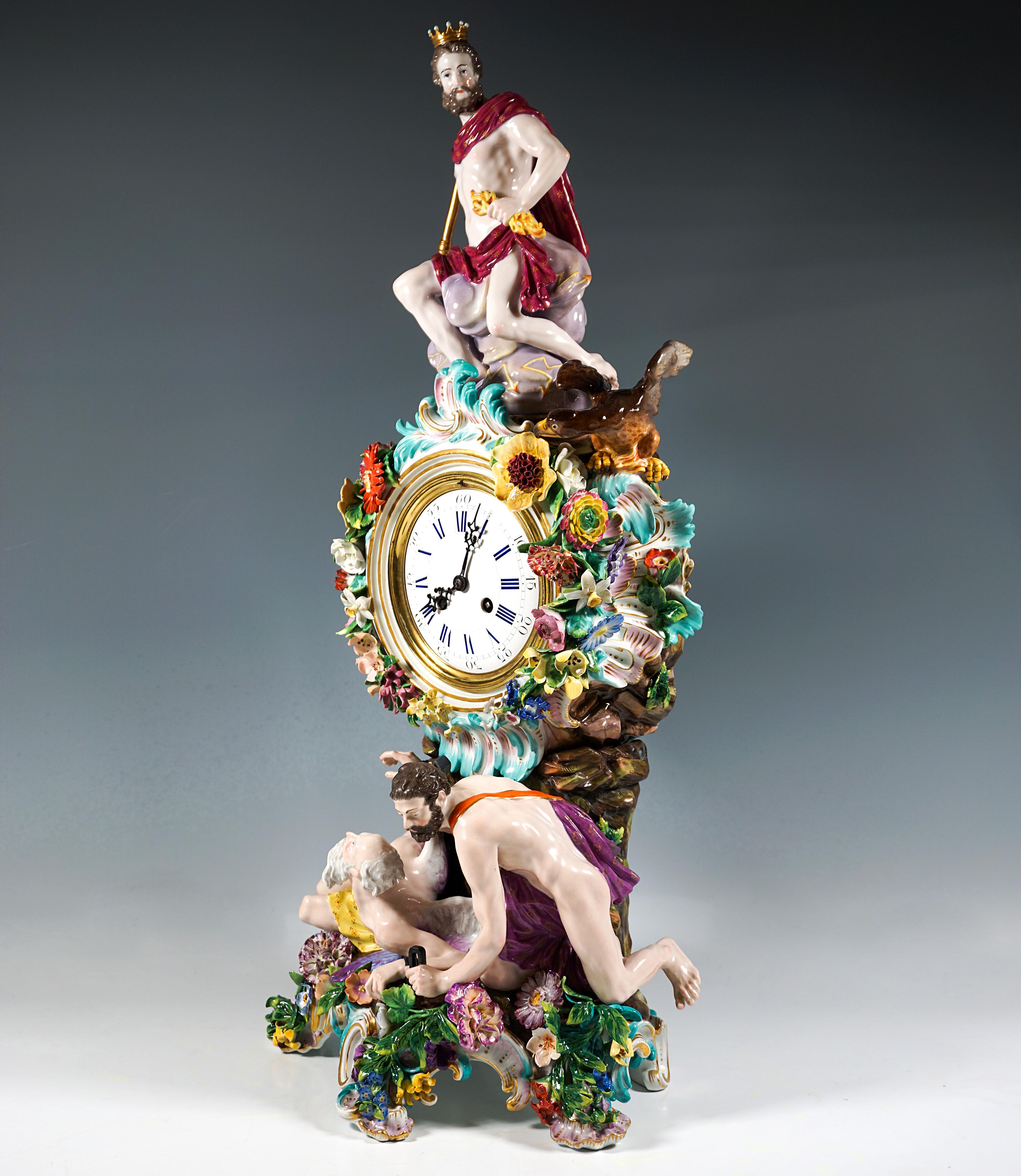 Clock case rising on a rock pillar on five sturdy, gold-highlighted rocaille feet, richly decorated with elaborately sculpted flowers, leaves and rocailles surrounding the dial, crowned with a Jupiter figure seated on a cloud throne, blooming in his