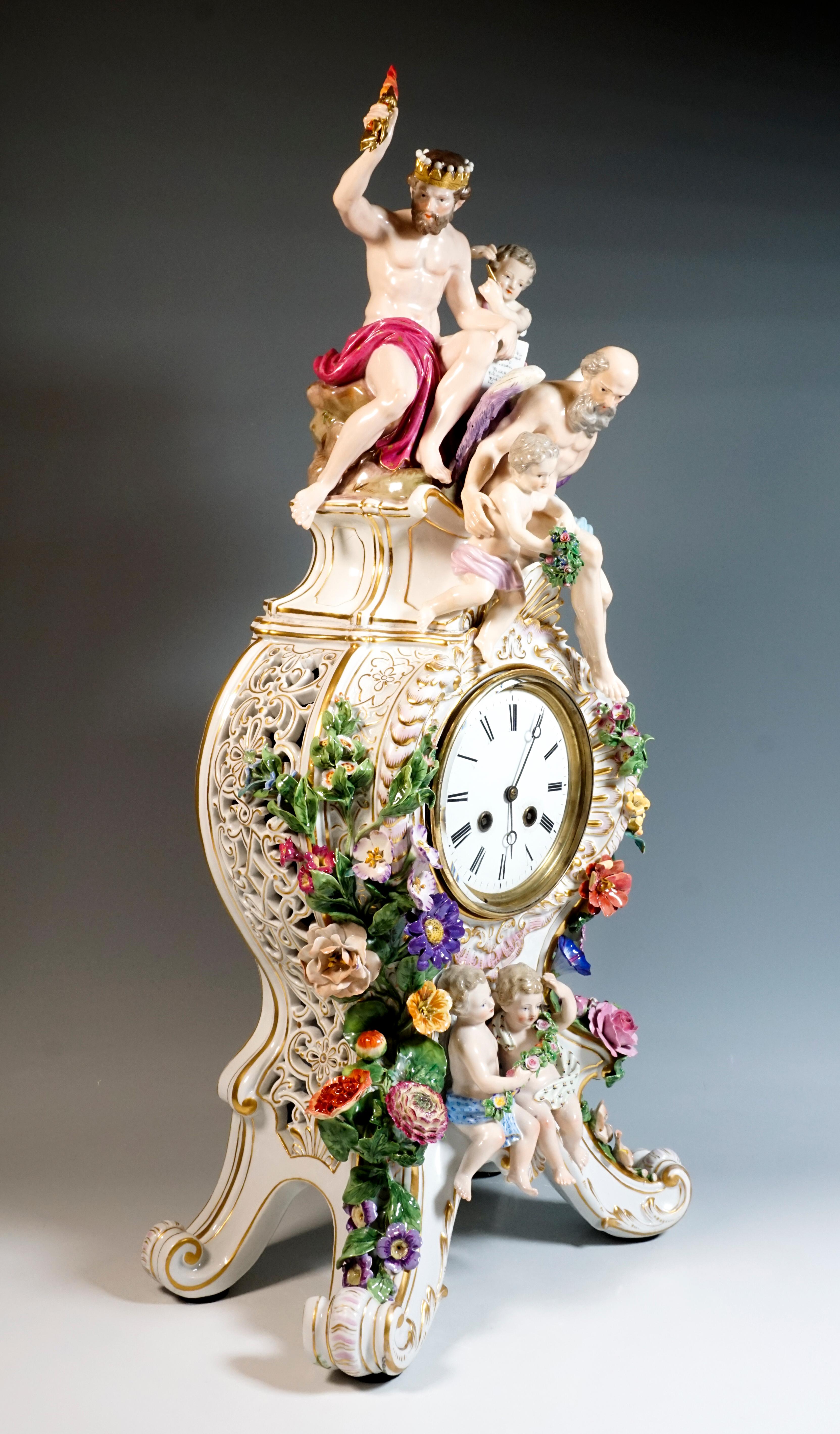 The clock was designed by Leuteritz in the Rococo style using old moulds: 
on four raised volute feet with gold rocaille ornamentation rises the clock case, open at the side by a volute and flower breakthrough work, richly decorated with elaborate,