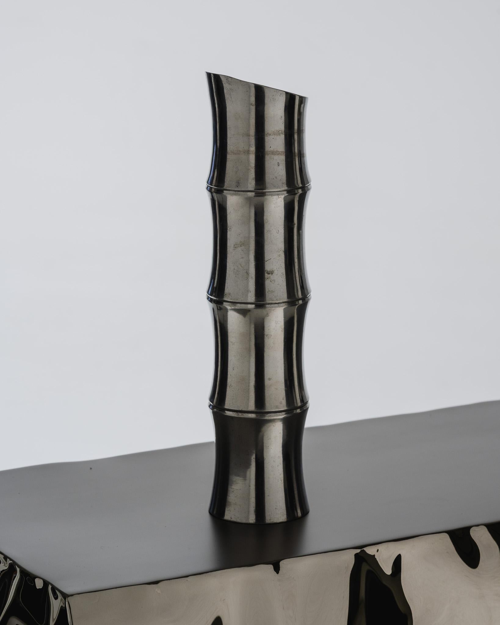 Large Metal Bamboo-Shaped Vase, 1970s.
An iconic Modernist piece, its vertical form, accented with ridges, combines organic and architectural shapes. Good overall condition.

DV4739