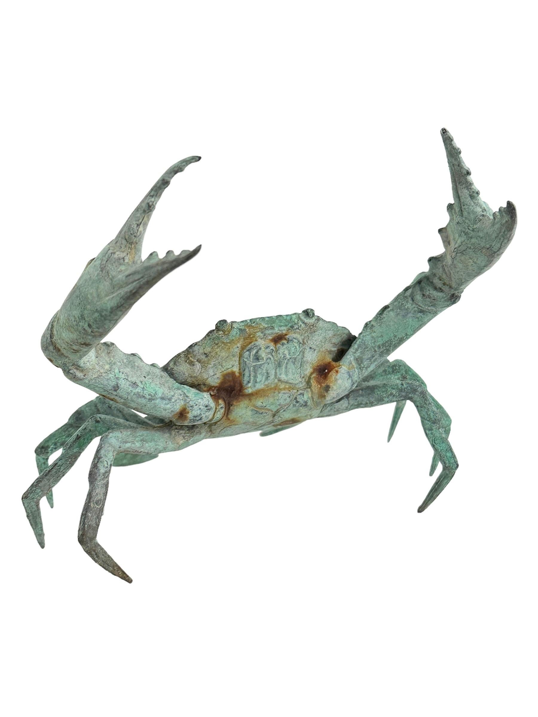 large metal crab sculpture in ocean