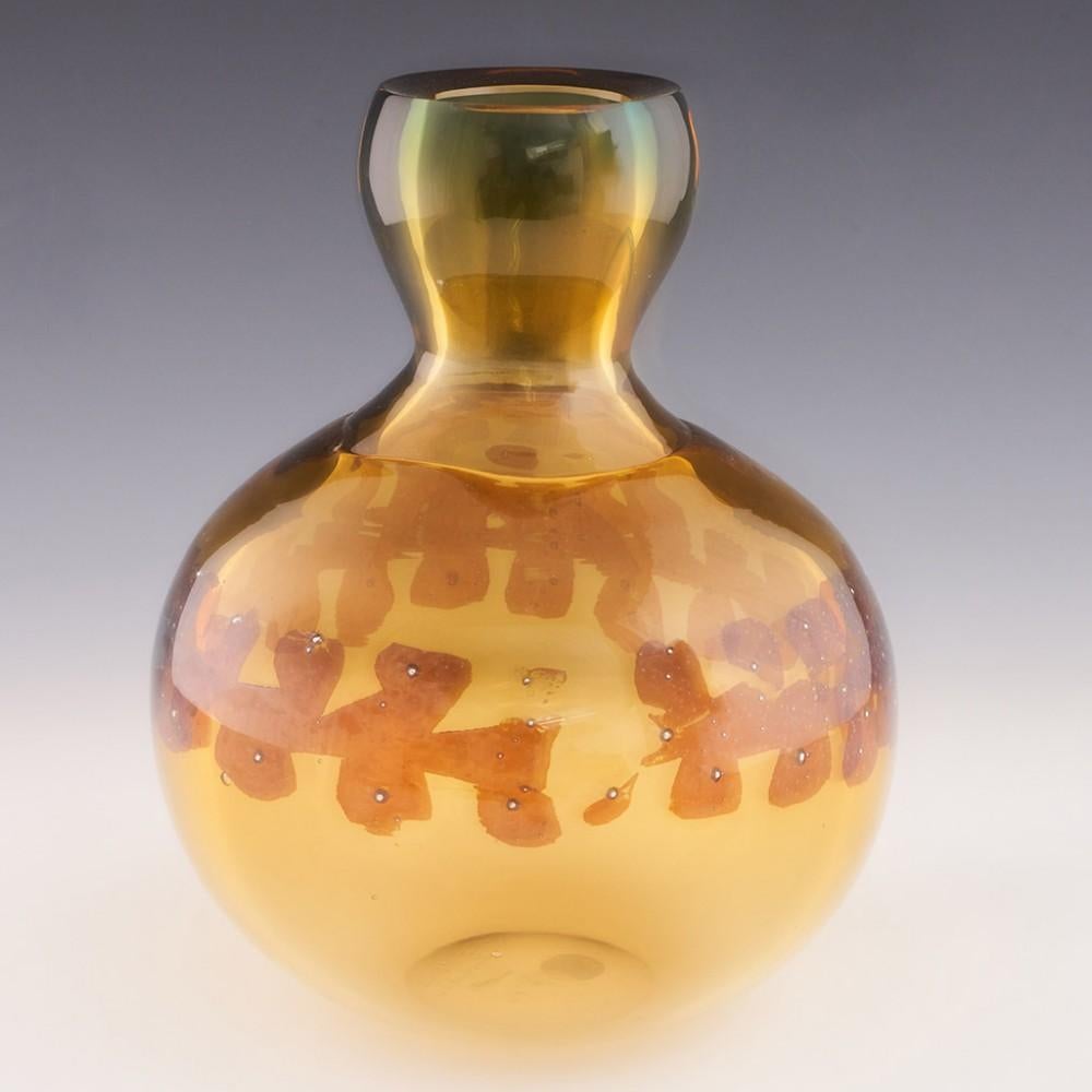 Heading : Pavel Hlava gourd vase
Date : c1970
Origin : Czechoslovakia
Bowl Features : Of gourd form in amber glass, which graduates to green at the top, a band of metal inclusions to the centre.
Marks : Signed P. Hlava Czechoslovakia to the base