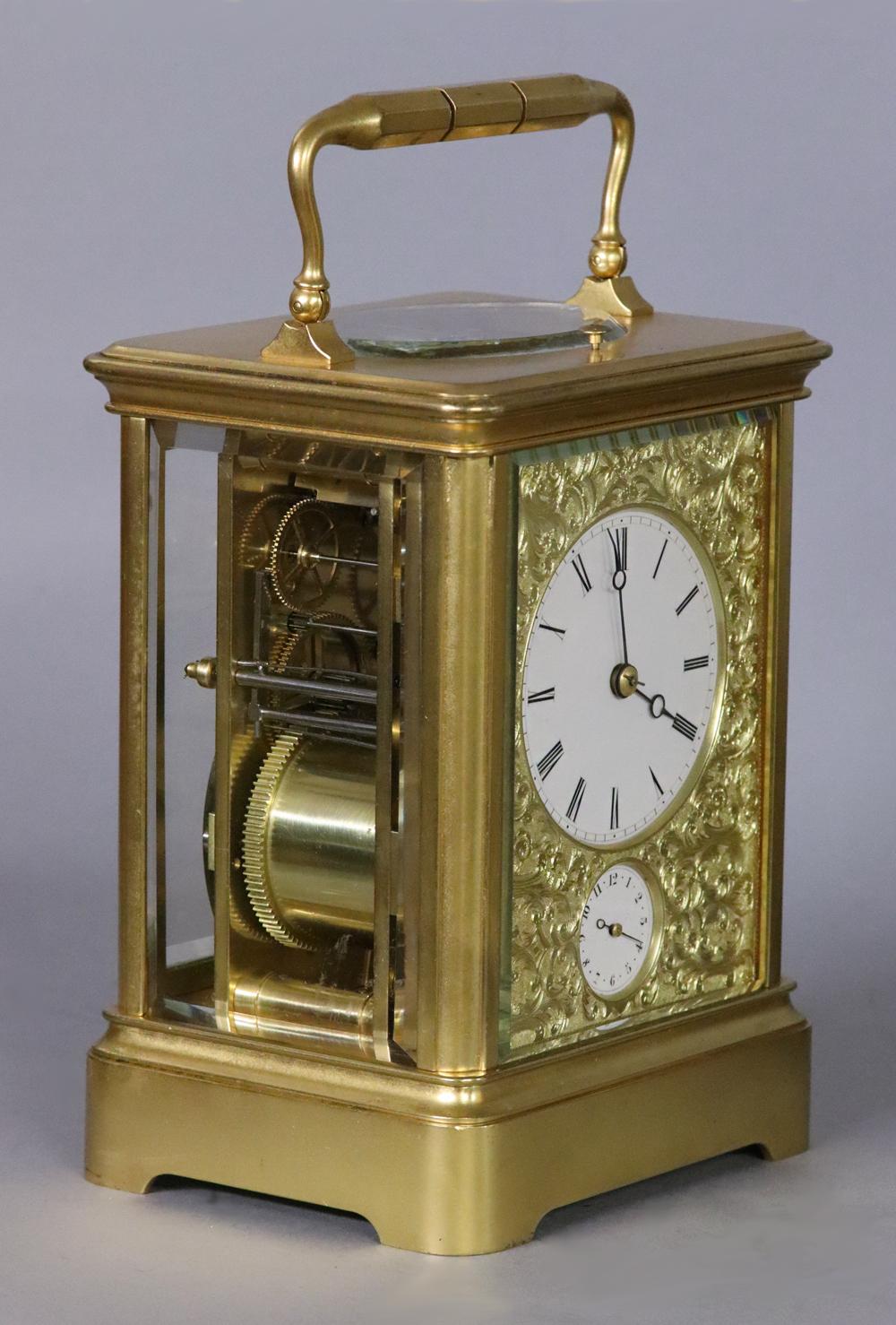 Maker: 
Drocourt, 7439.

Case: 
The large gilt-bronze early multi-piece case has a hinged handle above, beveled glasses to the sides and an oval viewing glass above.

Dial: 
The white porcelain dials for the hours and alarm have Roman