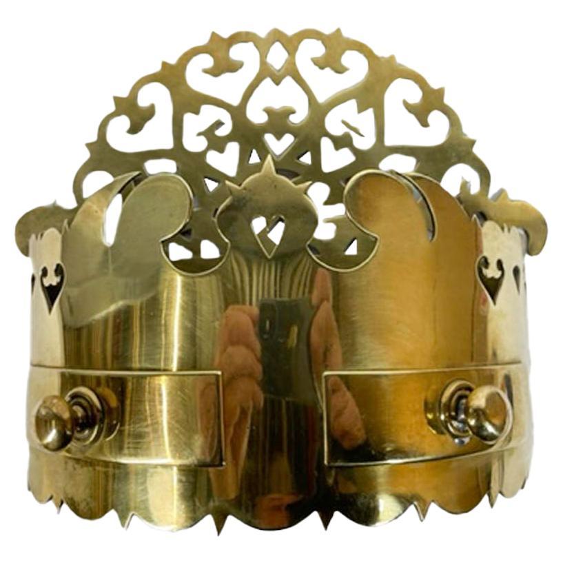 Mid nineteenth century pierced brass wall pocket or tidy. This unusual example with a shaped arched back pierced with hearts and other motifs above an open pocket created by the curved front panel with shaped top and bottom edges. The front also