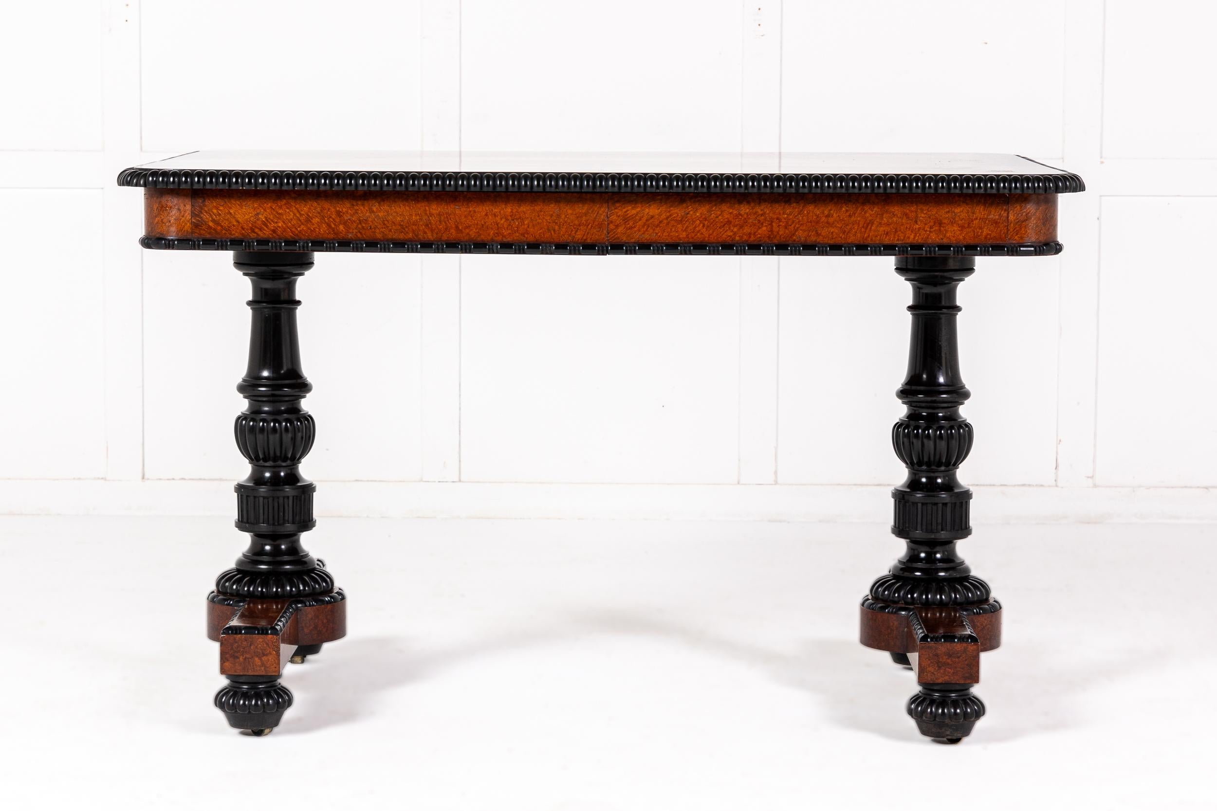 An Important Mid 19th Century Amboyna and Solid Ebony Library or Writing Table Attributed to Gillows.

This elegant table relies for much of its impact on the use of very fine burr amboyna veneers, enclosed within ebony mouldings. The top of the