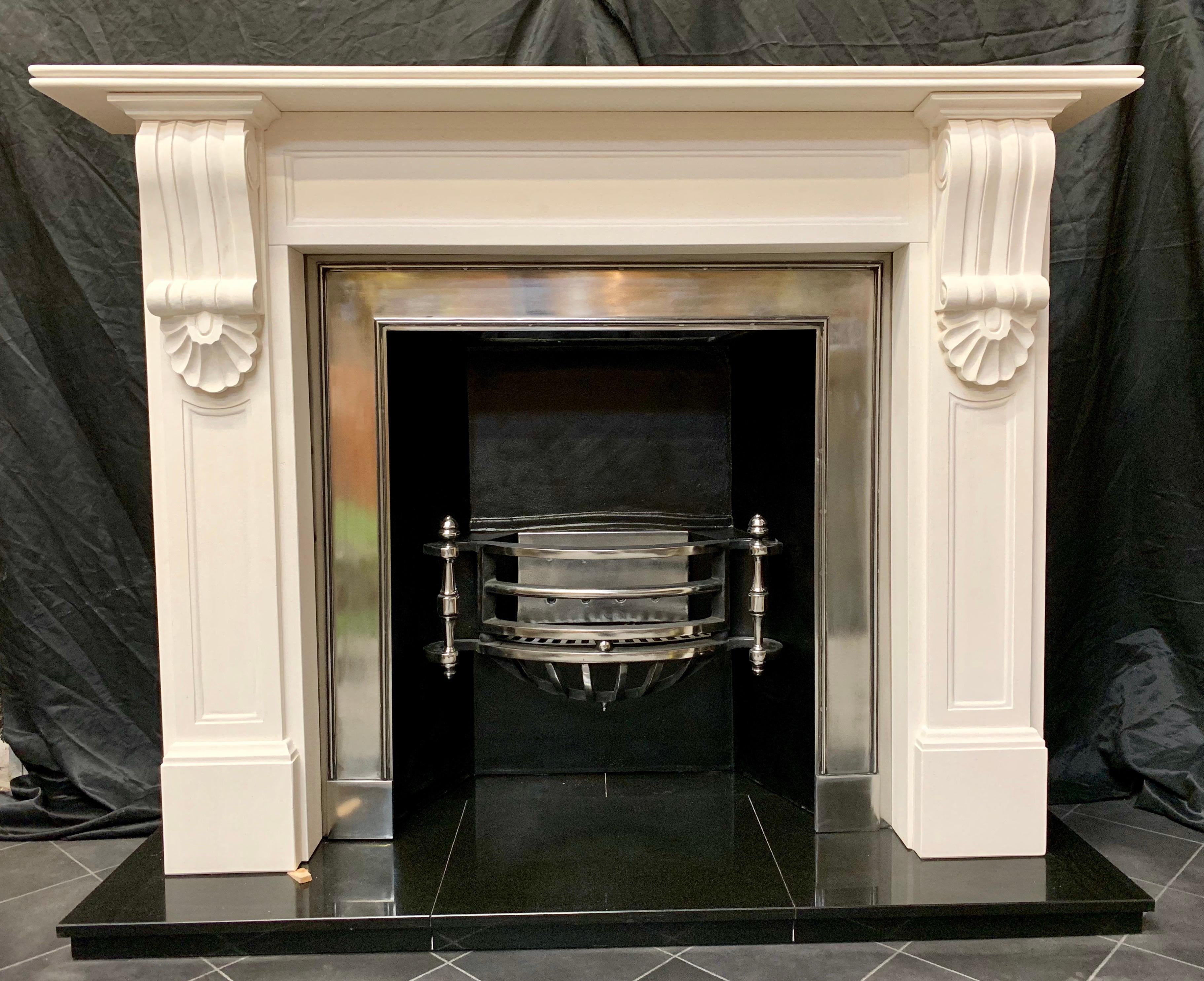 A large and masculine mid-19th century style limestone corbel fireplace surround, a double bullnose shelf sits above a recessed panelled frieze, flanked by a pair of large well carved corbels with capping and under shells, supported by recessed