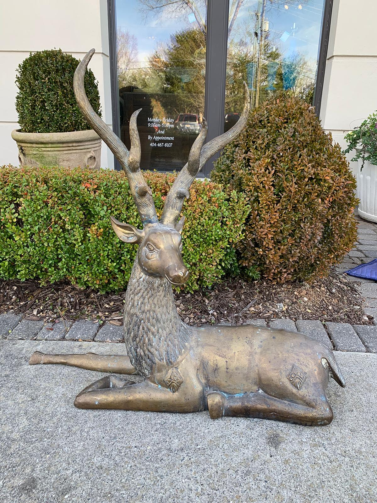 Large mid-20th century brass recumbent deer sculpture, circa 1970s.