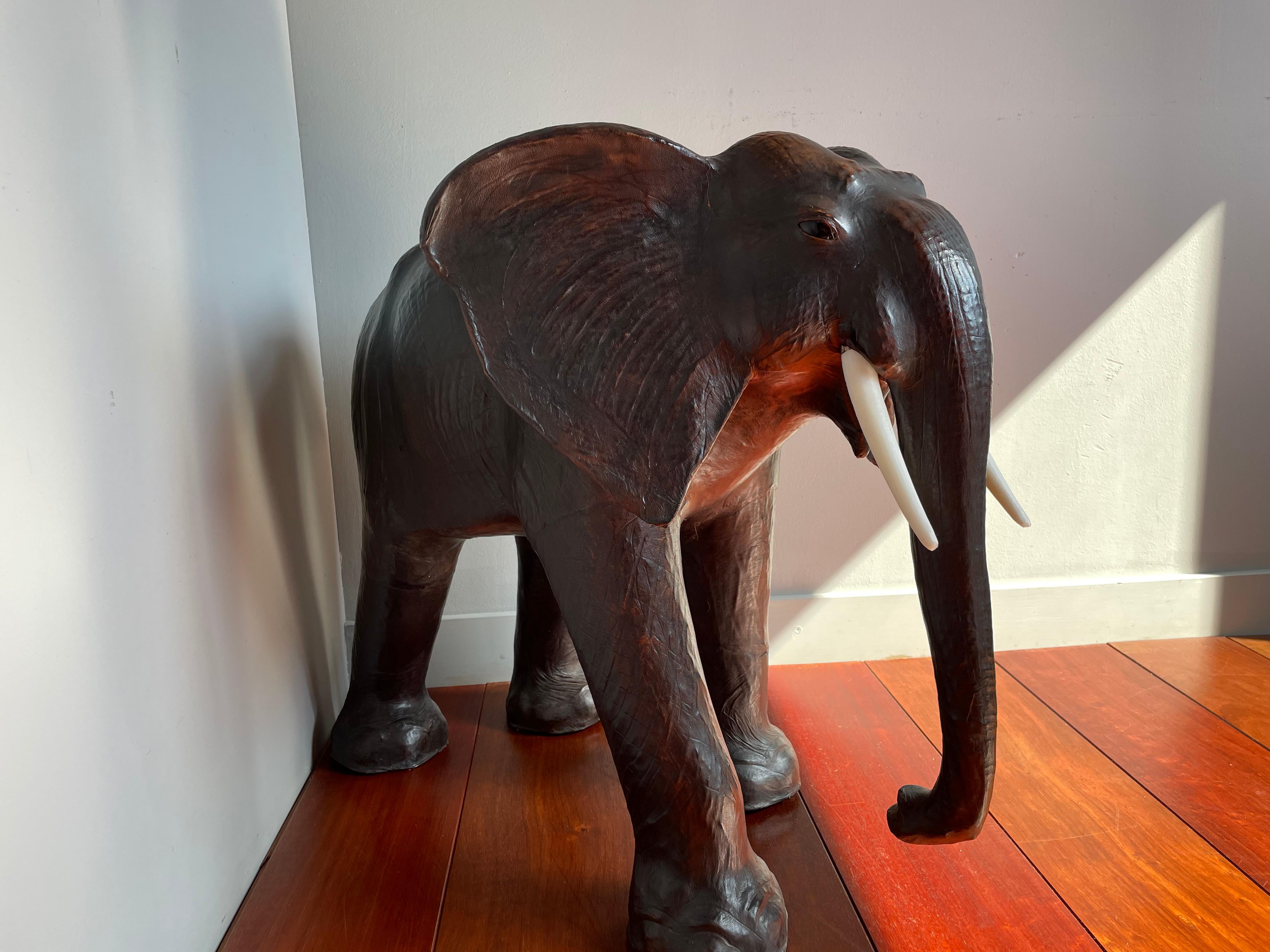 Good size and highly decorative wildlife sculpture.

This full-grown and impressive elephant has both great aesthetic and decorative value. Underneath the leather hide is a well carved wooden sculpture which is why this sizable tusker has such