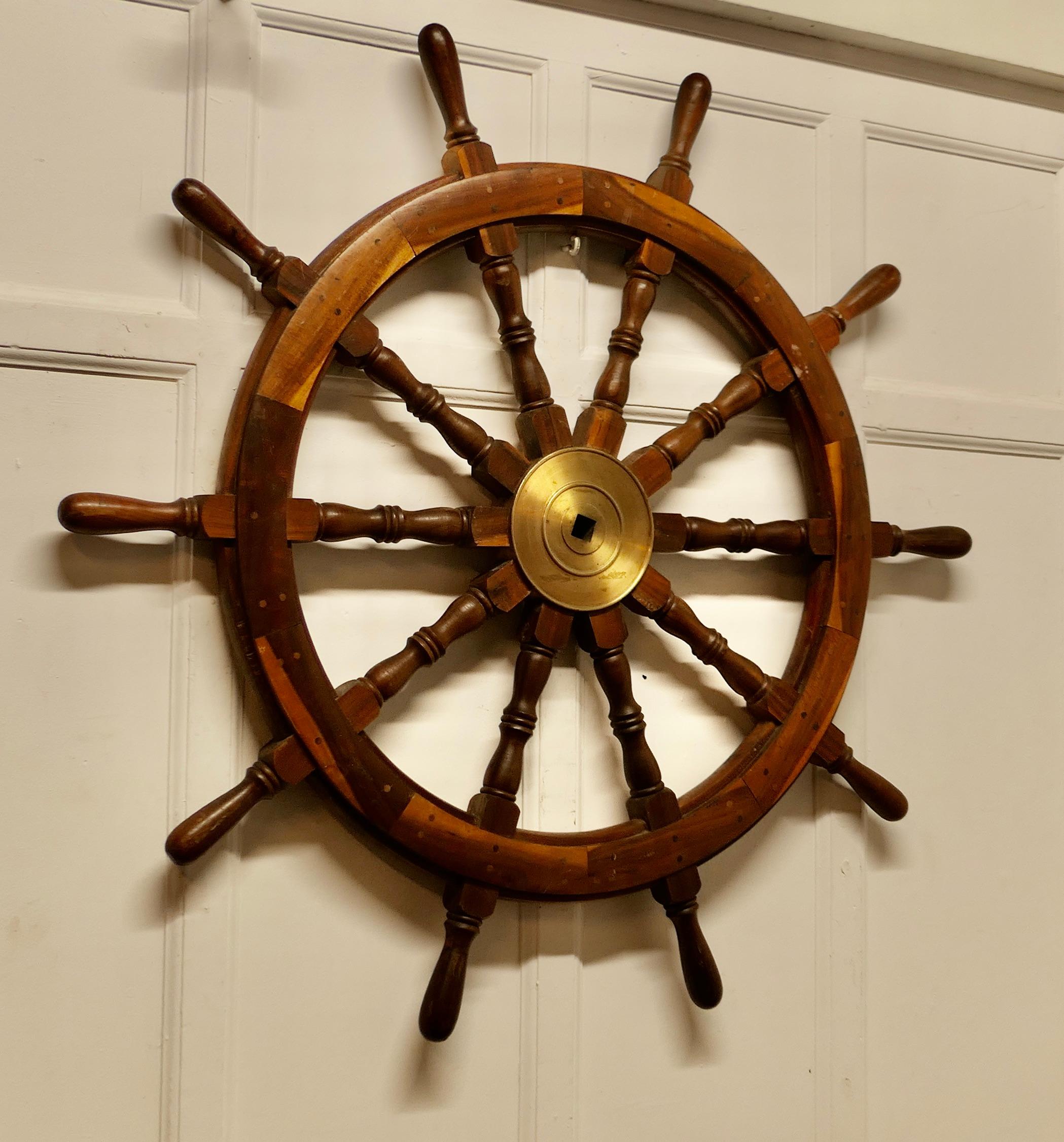 Large Mid 20th Century Teak Ships Wheel

A wonderful decorative piece, heavy and made in solid teak with Turned spindles radiating out from the central brass drum
The Wheel is 48” in diameter has 3” thick
TSC60