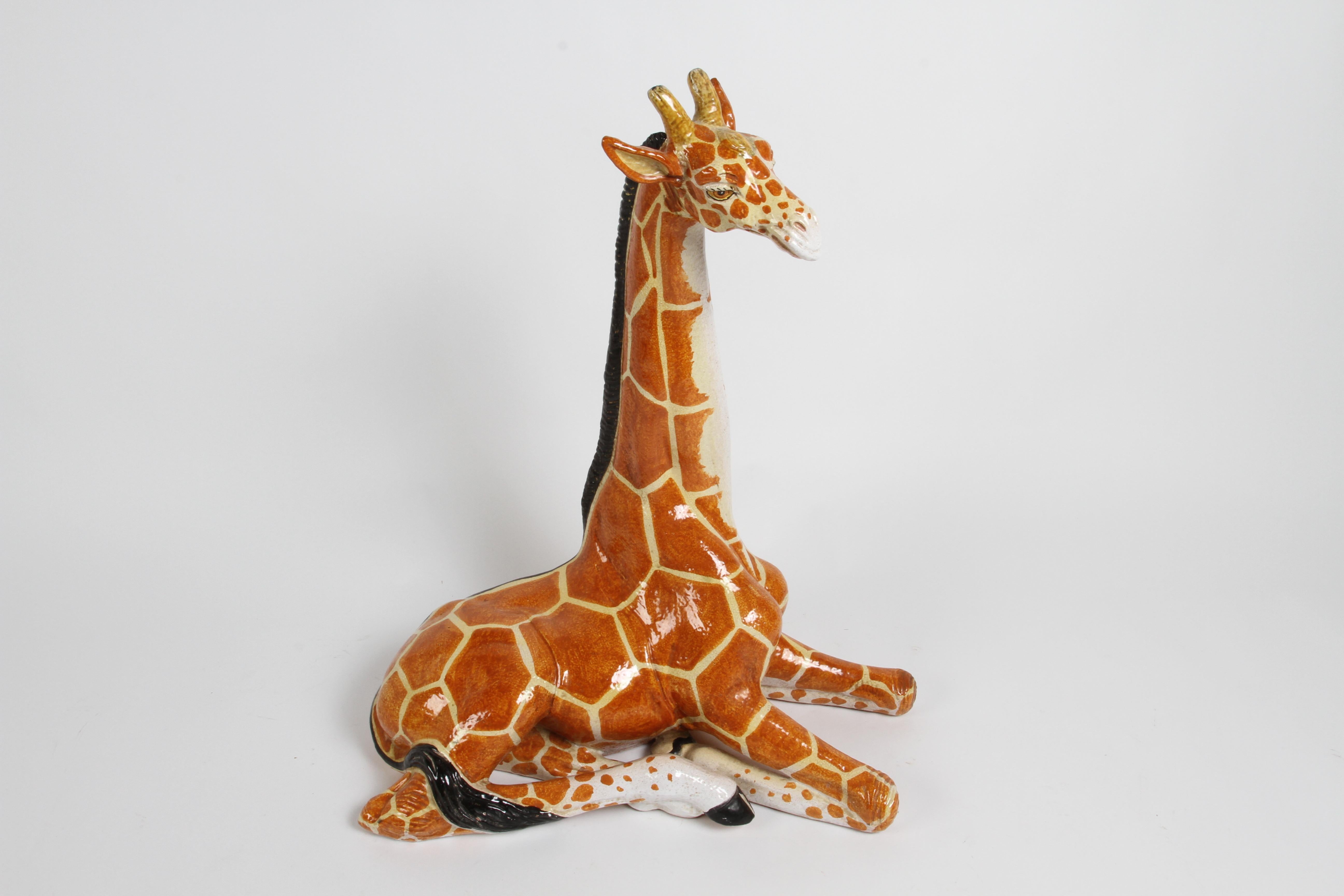 Large mid-century terracotta hand painted glazed whimsical Giraffe posed in lying position, made in Italy. In fine original , very little loss to glazing, as seen in the black mane. Stamped made in Italy. 