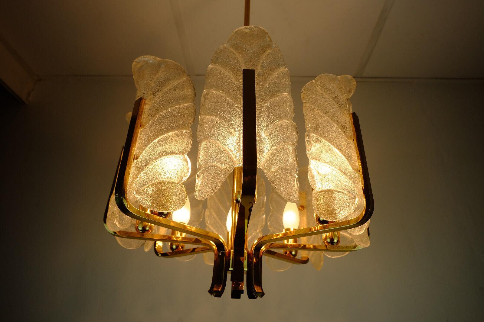 Large 1970s acanthus chandelier / pendant lamp with 8 leaf-shaped elements in clear glass. The frame is made of brass. Holds 8 E14 light bulbs (not included). Label inside the canopy: JBS (Josef Brumberg Sundern).

Very good condition, no damage,