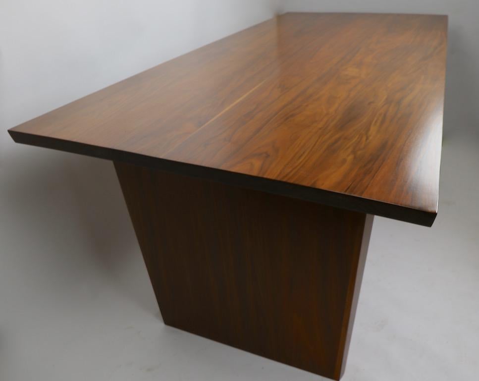 Incredible office desk, in solid walnut, with asymmetrical top, two drawers, paddle legs on wide edge, two tapered pole legs on narrow edge. Newly professionally refinished to perfection, clean and ready to use. Large and impressive, but not too big