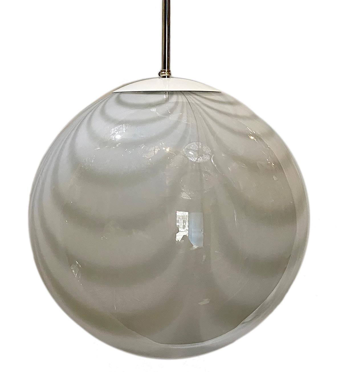 A circa 1960s Italian blown white clear glass light fixture with an interior light.

Measurements:
Diameter 16