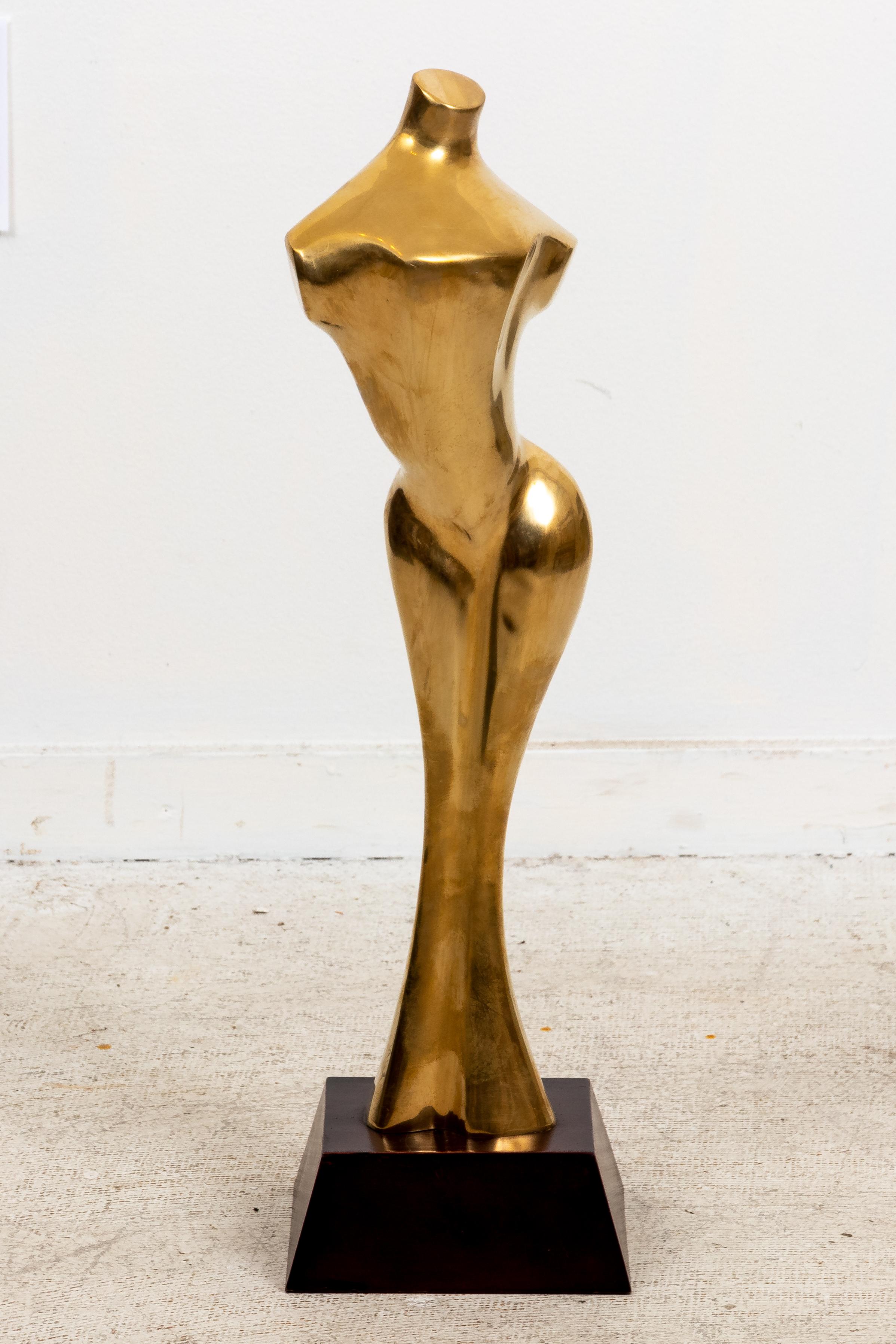 A very good quality decorative mid to late -20th century large hollow cast brass classical style nude torso sculpture in the manner of Jean Arp. Mounted on wood base.