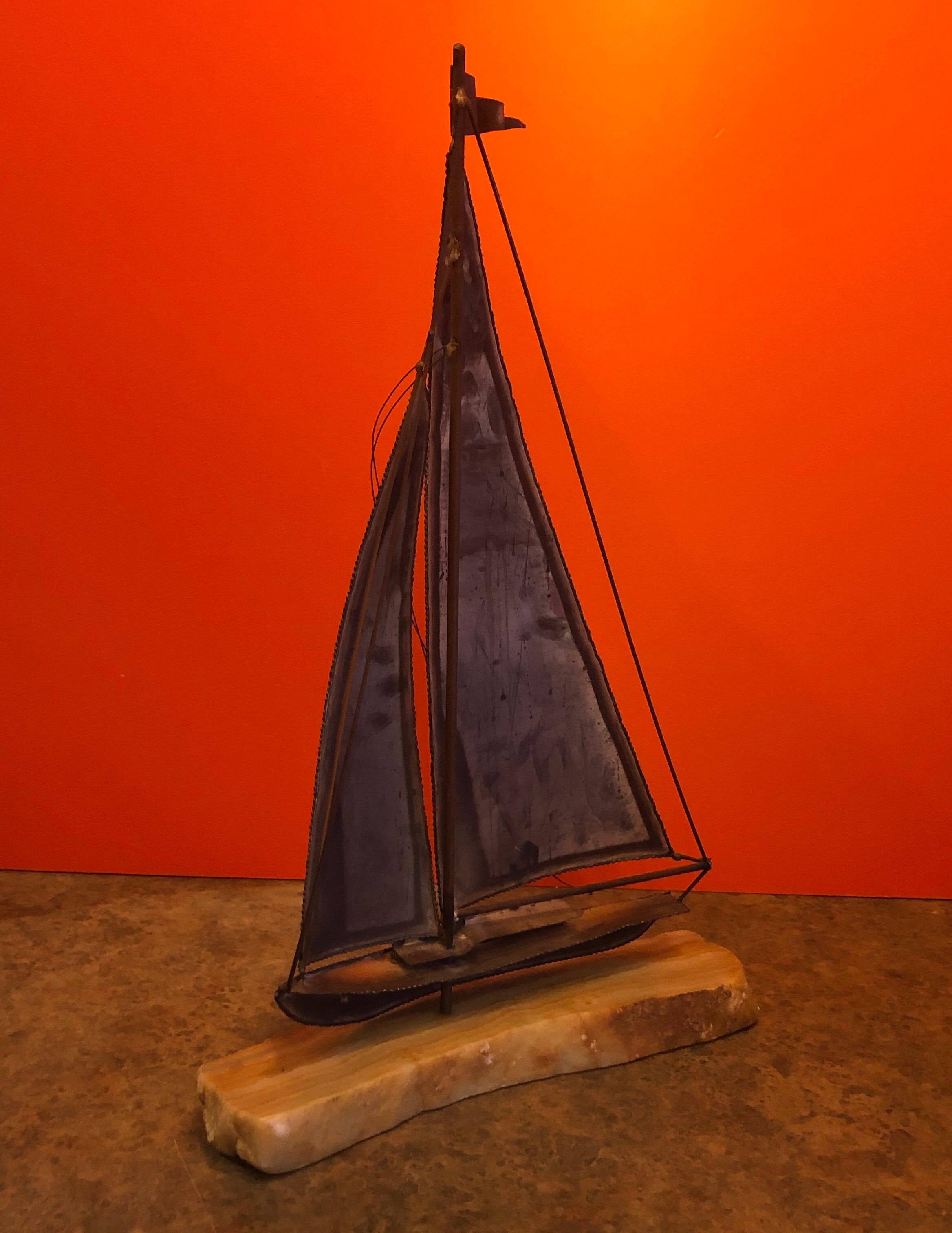 Large midcentury brass sailboat sculpture on onyx base by Demott, circa 1970s. The piece measures 14.5