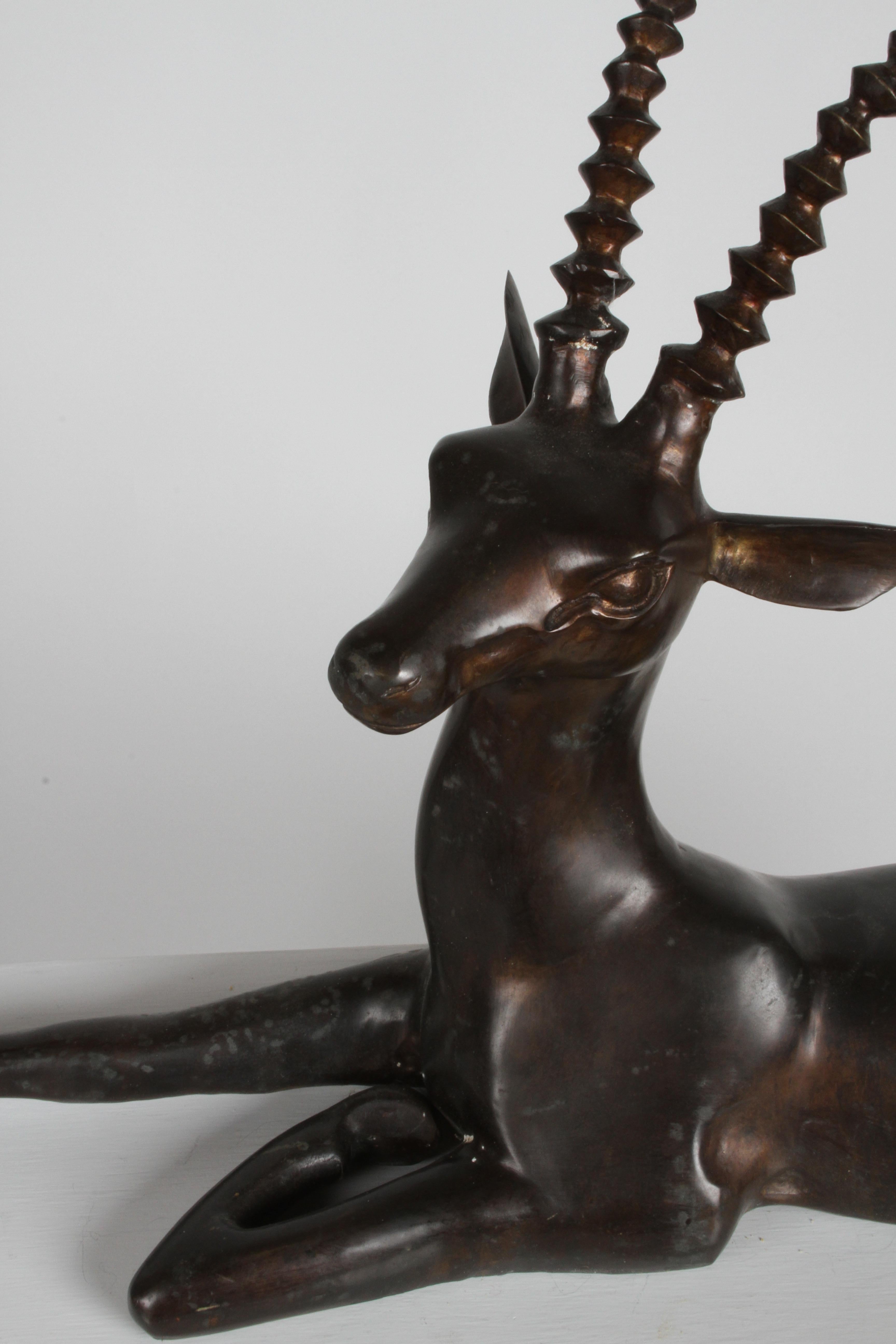 Large vintage bronze Gazelle sculpture in lying position with nice warm patina. Unsigned. Tape residue to underside.