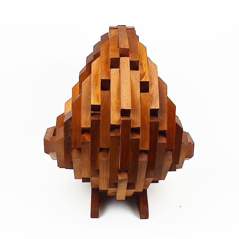 Sourced from the estate of an Oklahoma oil man, this whimsical piece of tramp art will be a focal point in any space. Constructed of what we believe to be teak wood, identical pieces were carved and affixed to one another to create a basket style