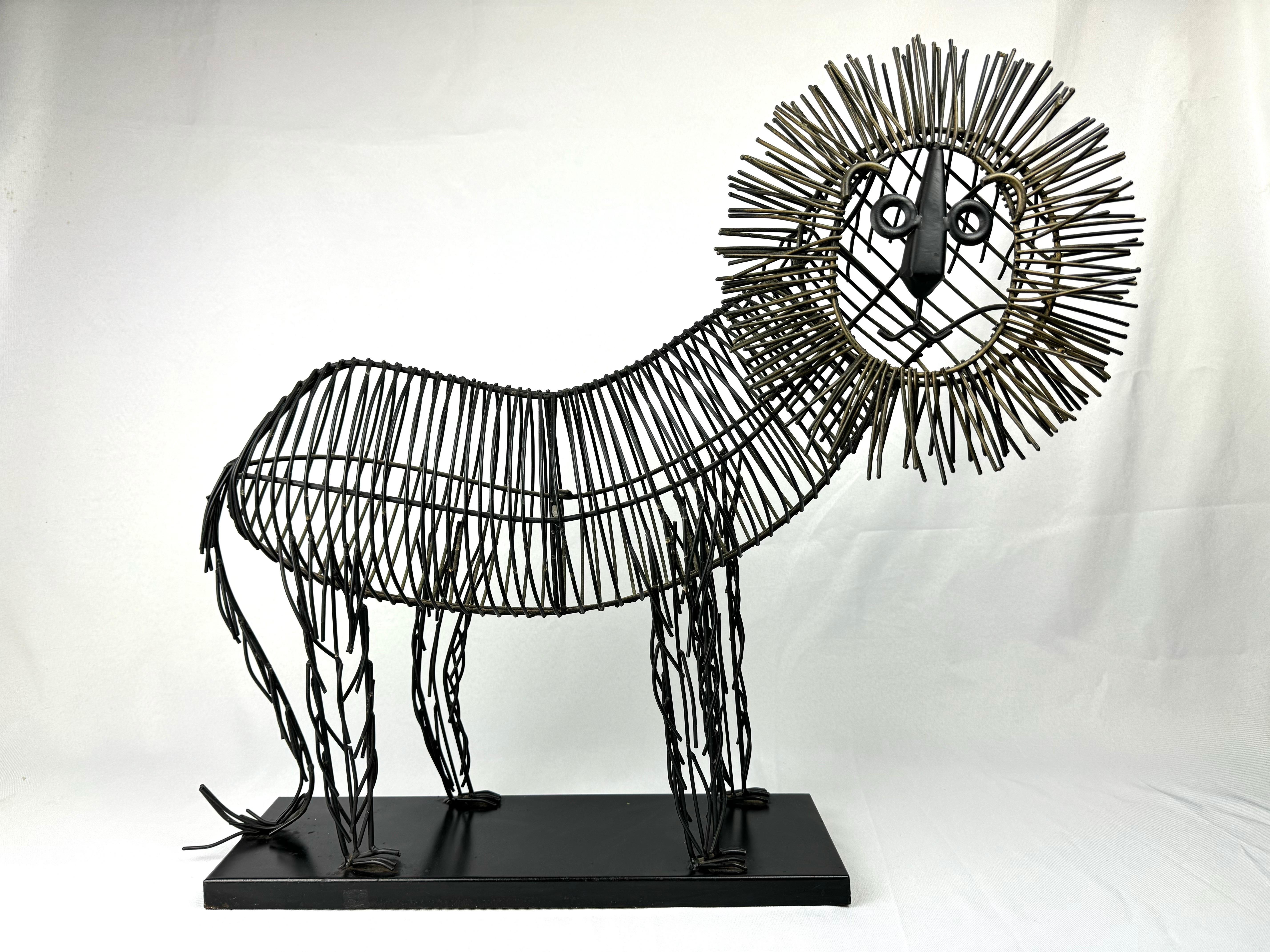 Mid Century Brutalist Lion Sculpture. Classic design made out of thick metal wire in colors of black and gold. Supported by a black metal base,