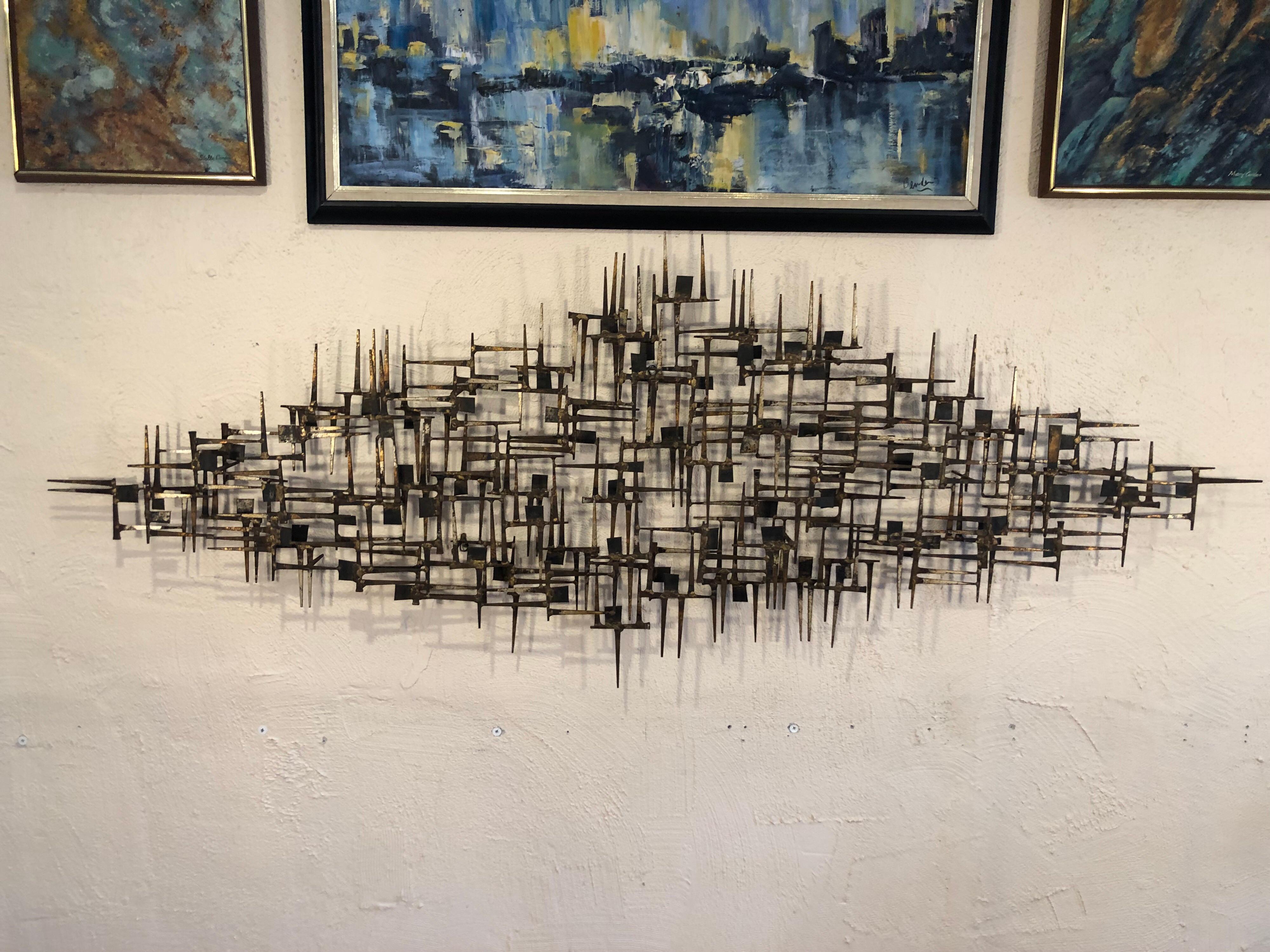 Large midcentury Brutalist nail wall sculpture attributed to Marc Weinstein. Amazing 3 dimensional hand welded and torch cut nail art with squares design. Perfect focal point for above a sofa or bed. No signature found. Can be hung vertically or