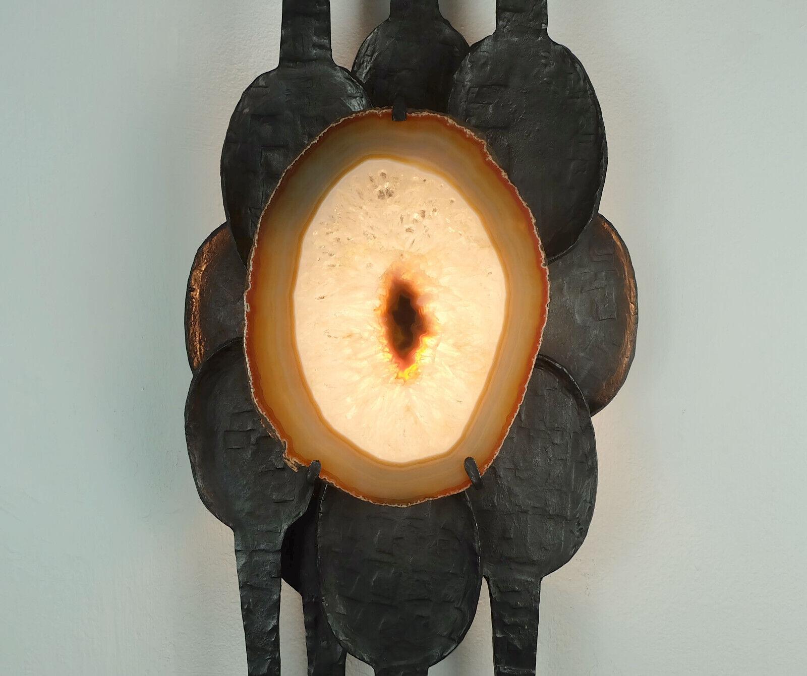 Outstanding large mid-century brutalist style wall sconce made of wrought iron and agate. With a drawbar switch on the lamp, covered by one of the iron elements. Holds one E14 socket. Wiring for international use.

Dimensions in cm:
Length 82 cm,