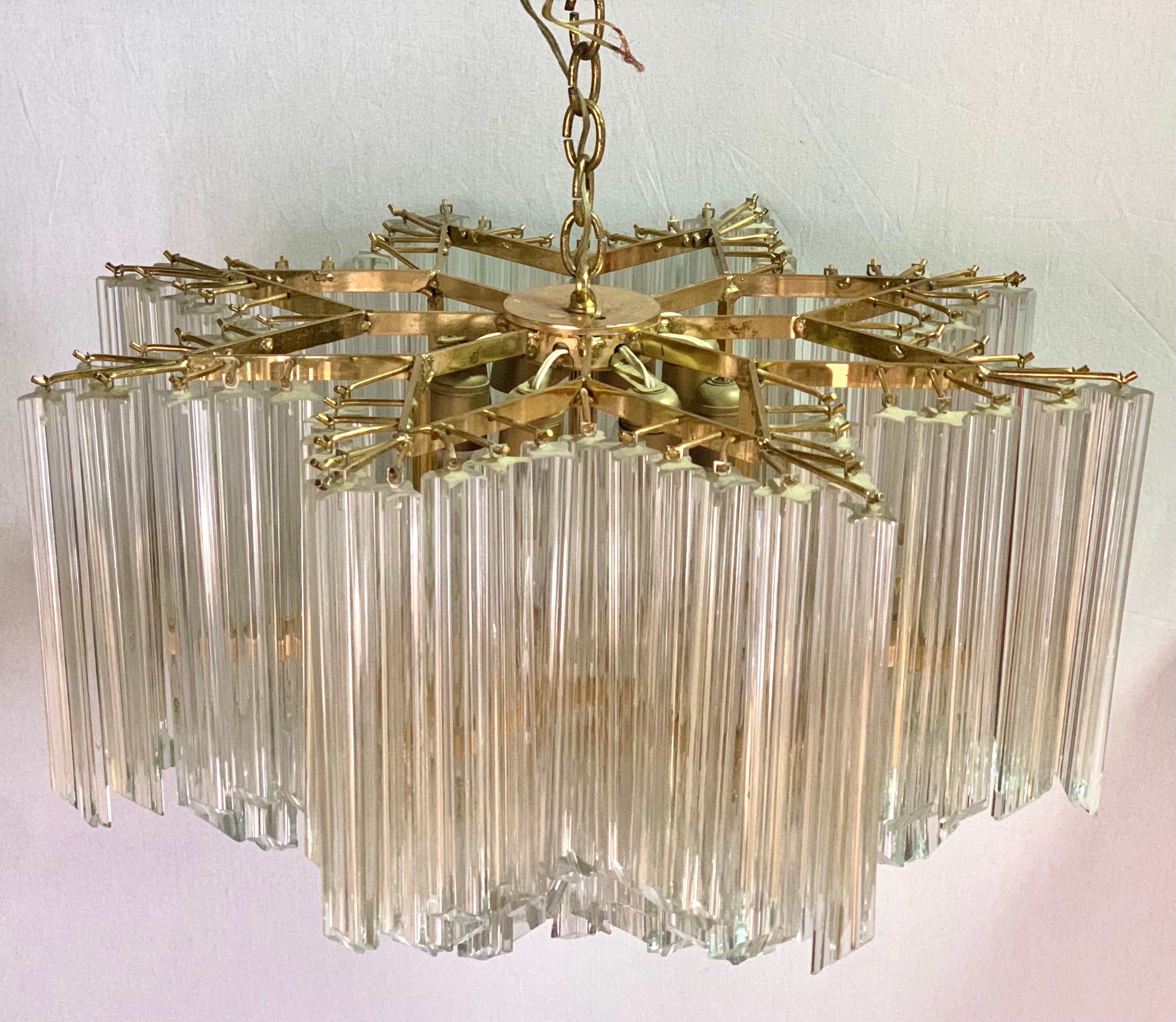 Magnificent large Camer Glass mid century modern chandelier featuring murano glass hanging prisms throughout. Each prism has a hook and hangs straight down from a star shaped fixture There are two different length prisms that, when hung, make this