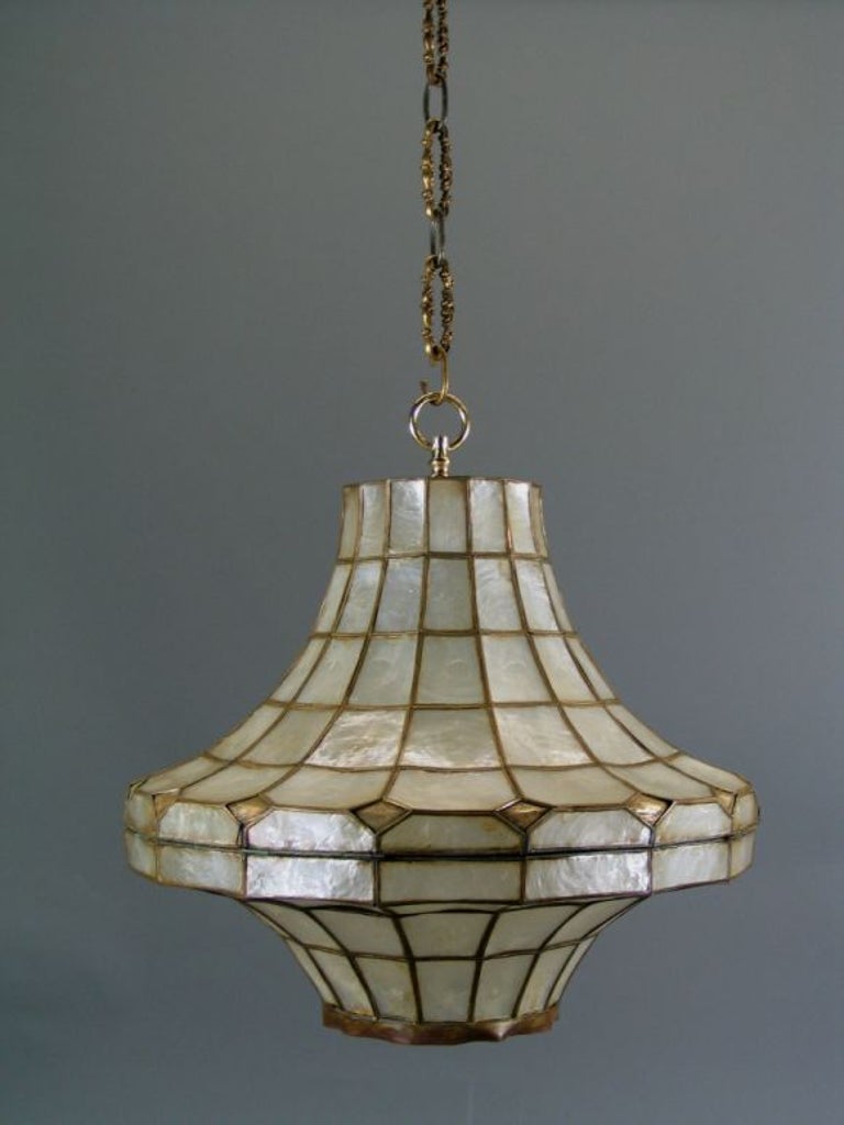 capiz shell pagoda shaped lantern with brass frame. 
Two available. Priced individually
Imperfections in shell
Takes one 100 watt bulb
