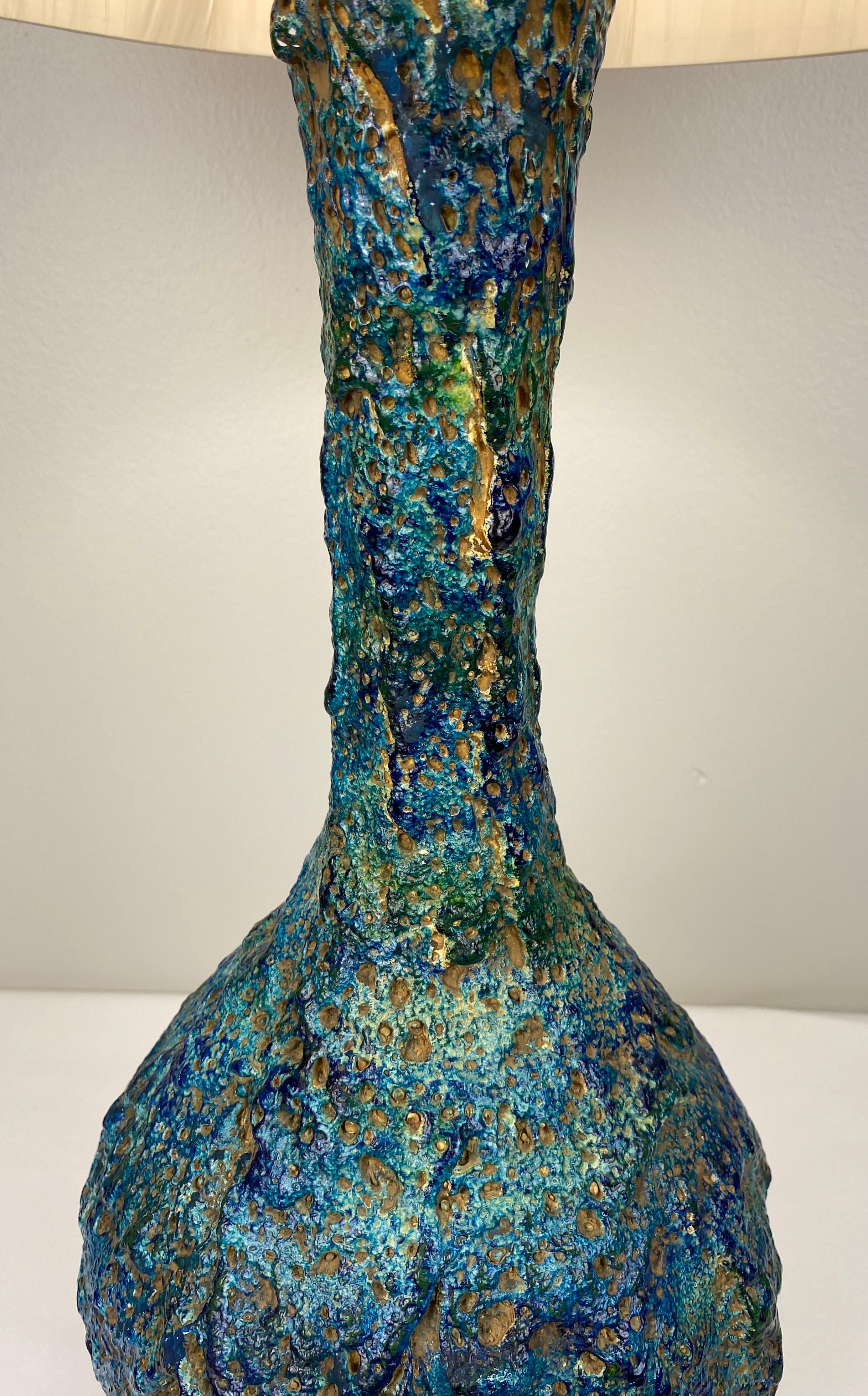Large and very decorative ceramic table lamp from France. Very attractive mid-century modern ceramic table lamp with beautiful blue colors and a great form. This lamp has notable sculptural work.  Quite unique with a glamorous appearance. 

This