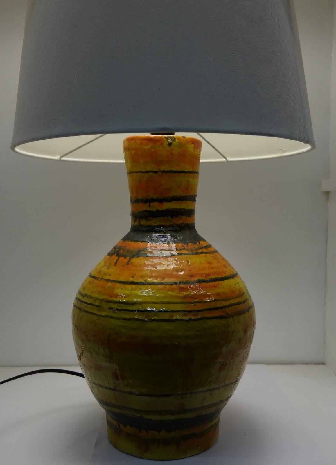 This large signed and handmade ceramic lamp was made in the 1970s. It features a glossy glazed finish and it's an individual, large format piece. Signed on the top: ZSH. From the artists collection.

Born in 1953 in Budapest, G. Zsuzsa Heller