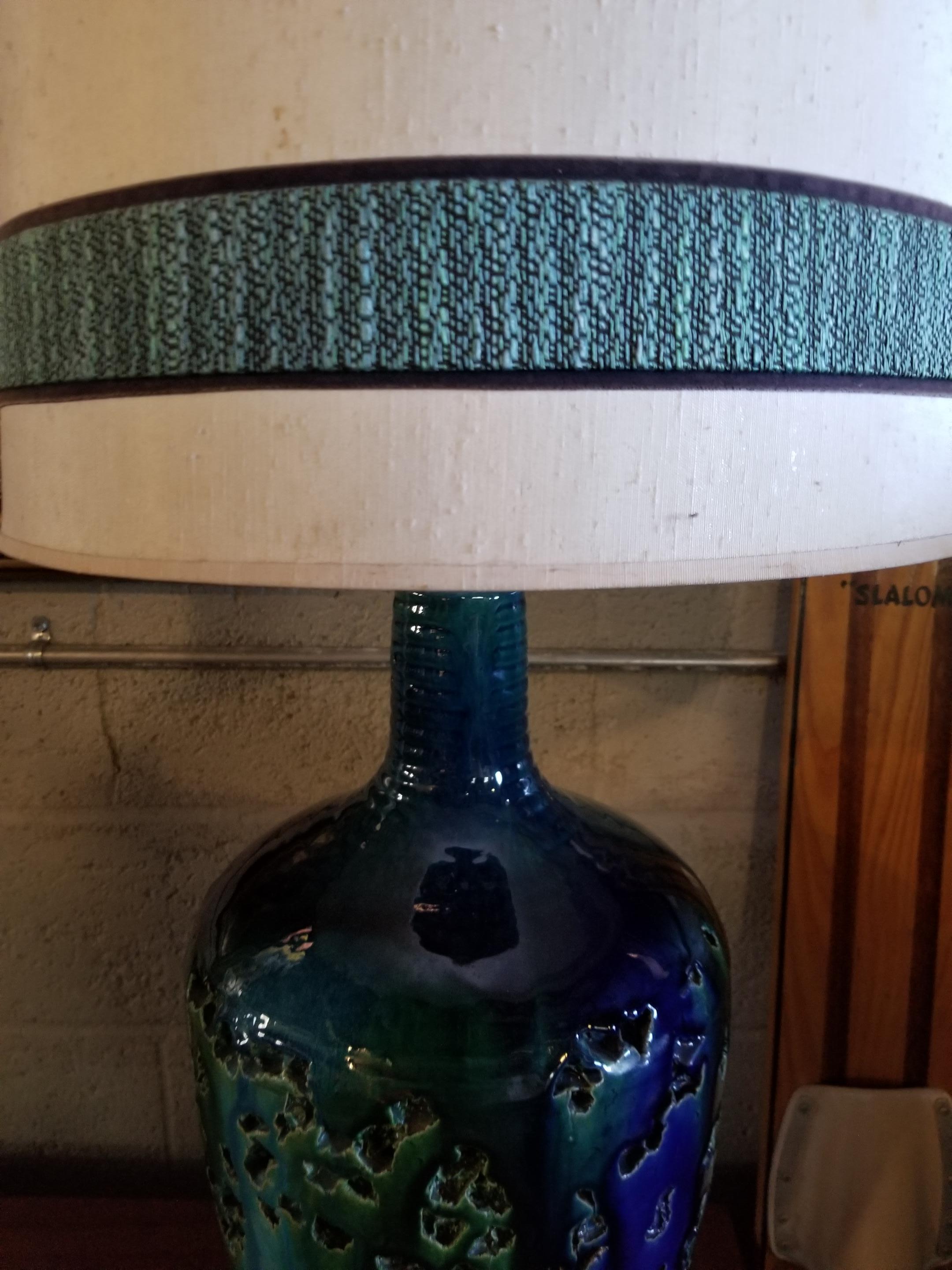 Beautiful, oversized, deep textured ceramic table lamp with blue and green drippy glaze. Includes period lamp shade. Turned wood base. Original working wiring. Glaze colors similar to the Rimini Blu used by Aldo Londi / Bitossi. Shade only measures