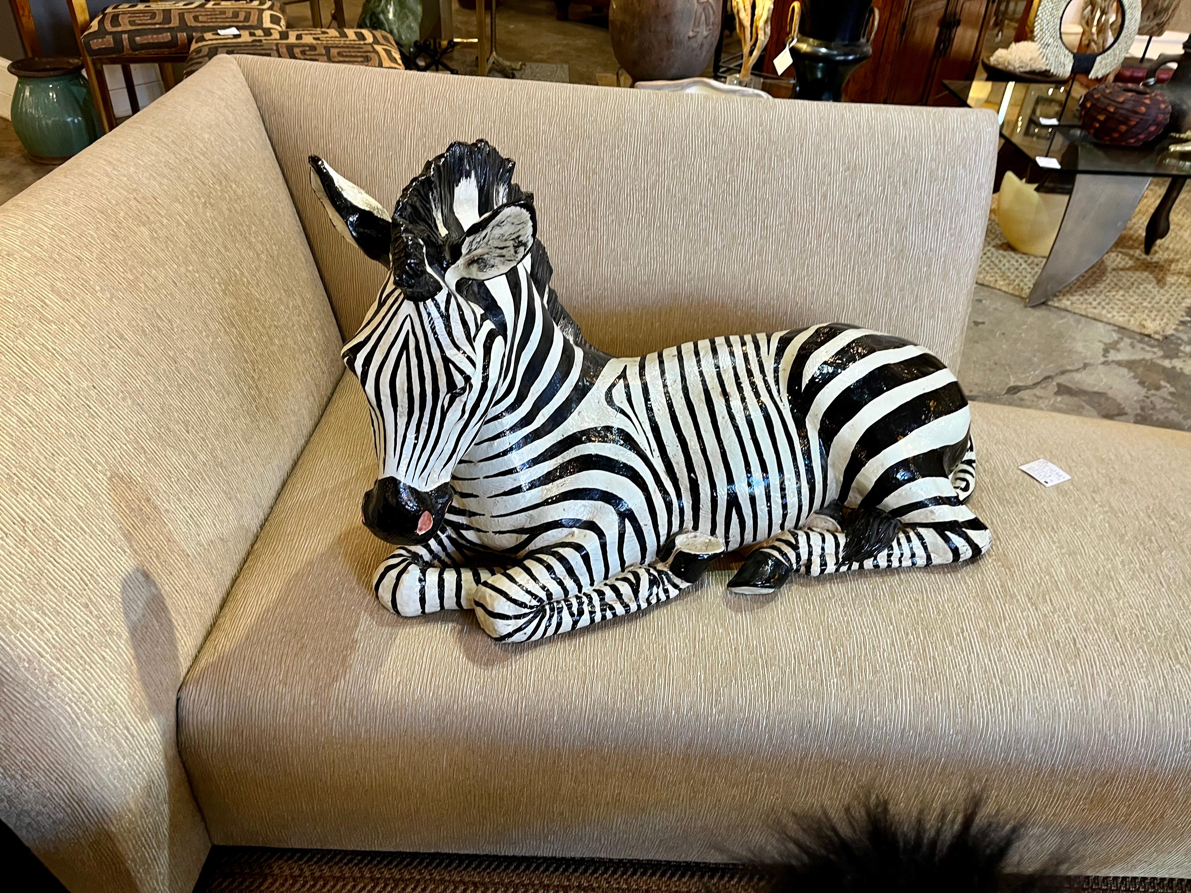 A 1960s monumental Italian ceramic figural zebra in a recumbent style. This piece is not signed, but most likely made in Italy.   Charming because of its large size.