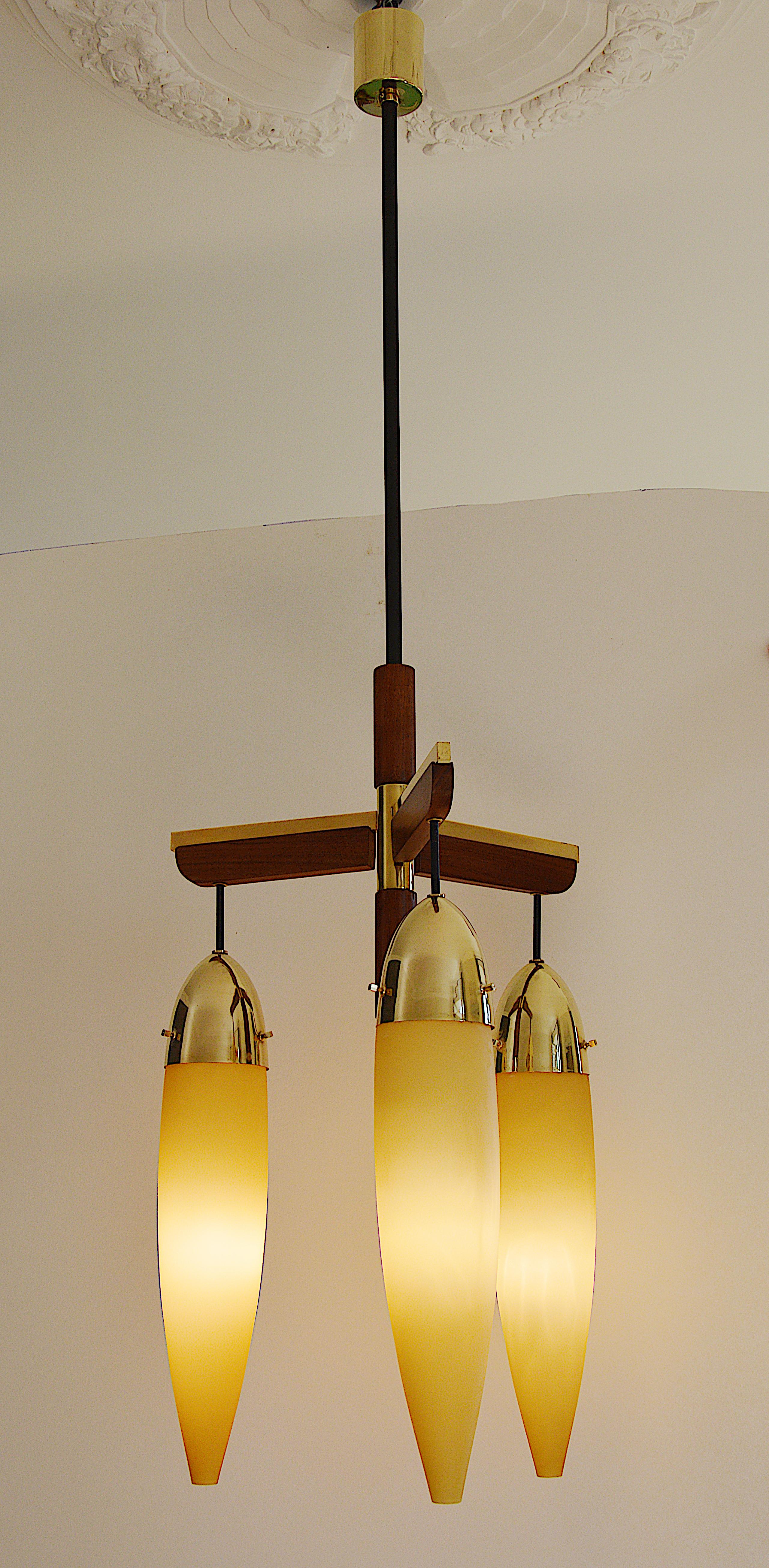 Large Mid-century chandelier, 1950s. Teak, brass and glass. 3 beautiful double glass shades. white inside and yellow outside suspended from a long and very elegant frame. The general effect is delicacy and refinement. Height : 51