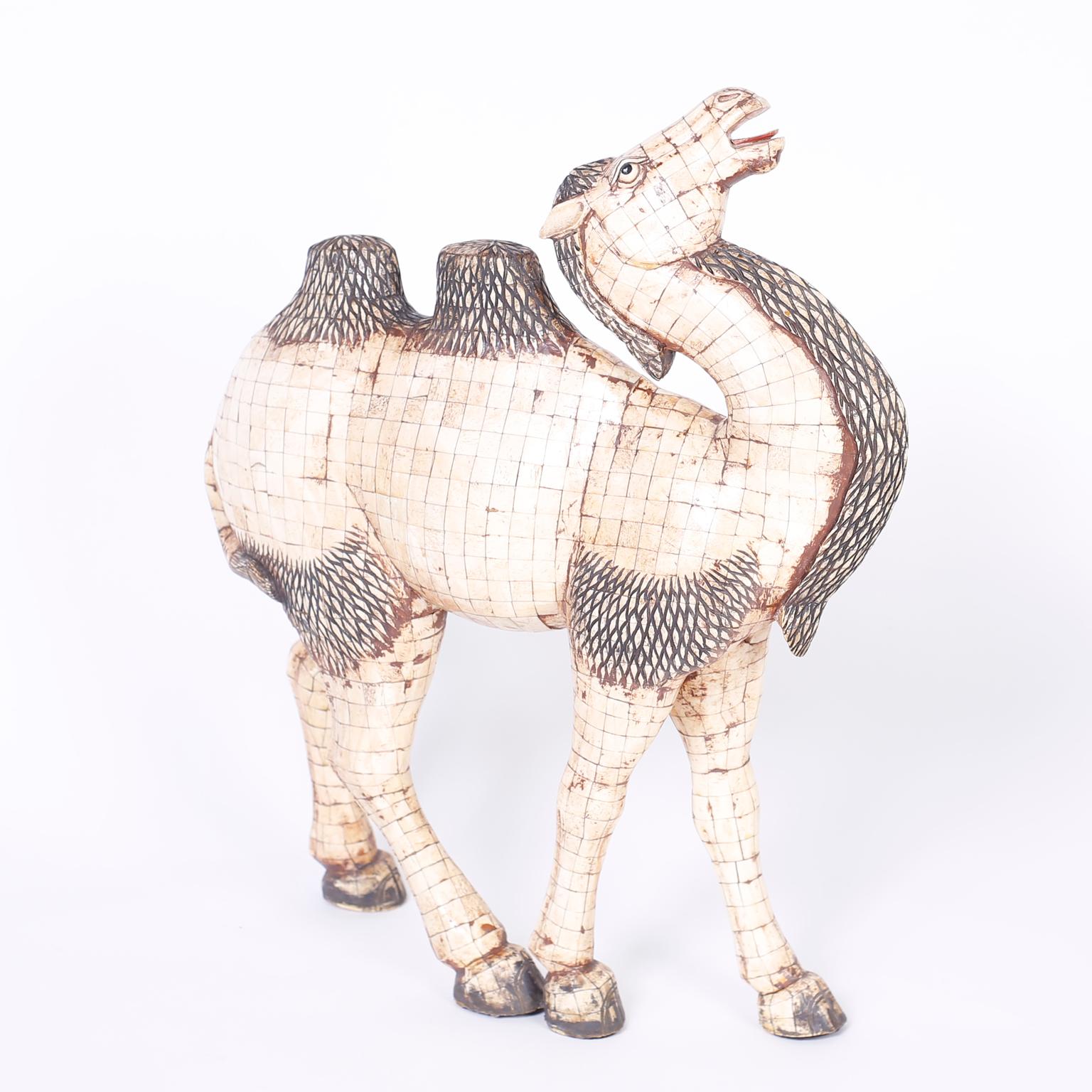 Impressive Chinese stylized camel caught in a whimsical pose crafted in tessellated bone veneer and carved bone over carved wood.