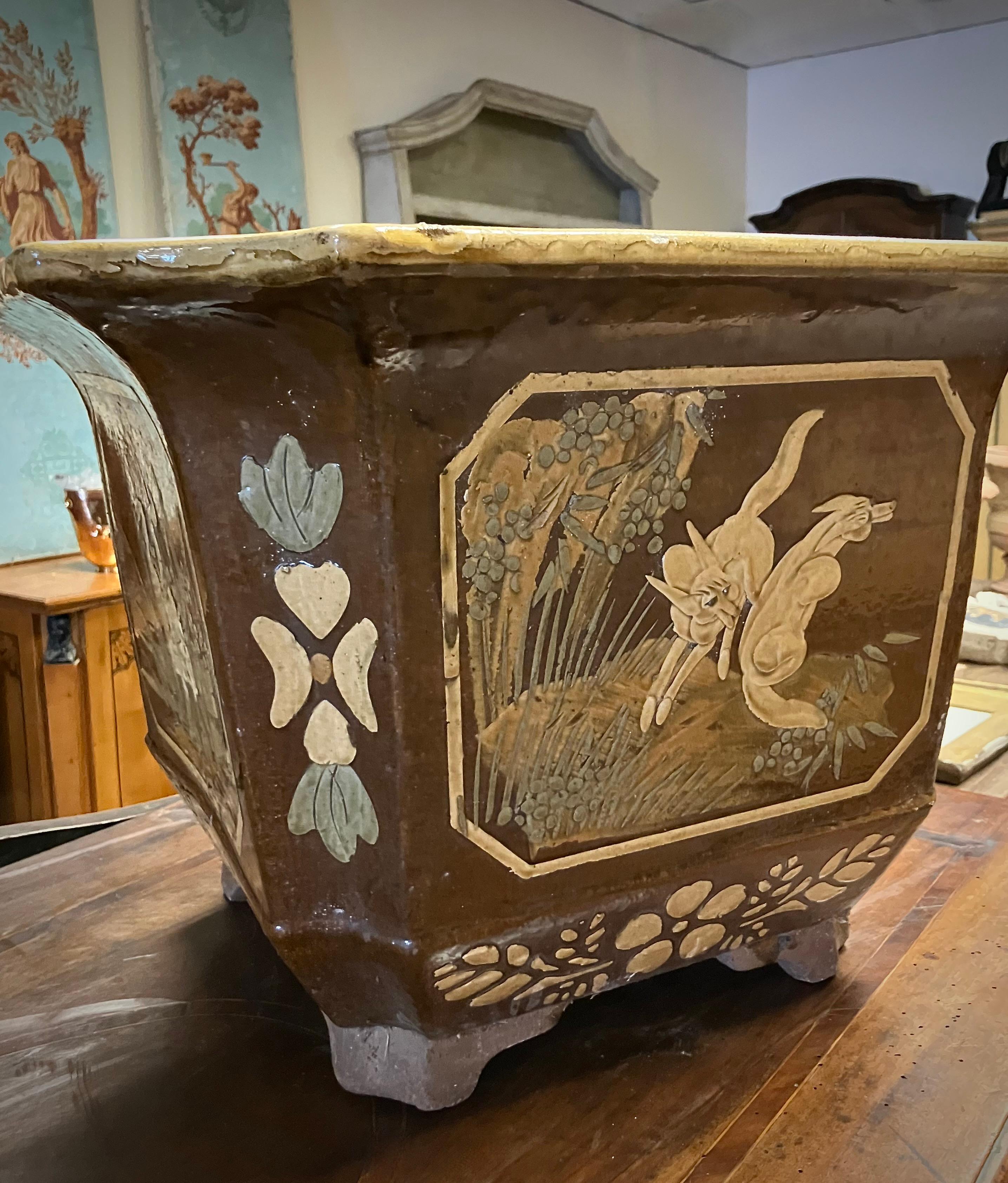 These large mid-century chinoiserie terracotta planters or cachepot are the perfect blend of vintage charm and exotic allure. 
Crafted from glazed terracotta, these planters boast a rich, earthy palette of ochre, brown, and verdant greens that evoke
