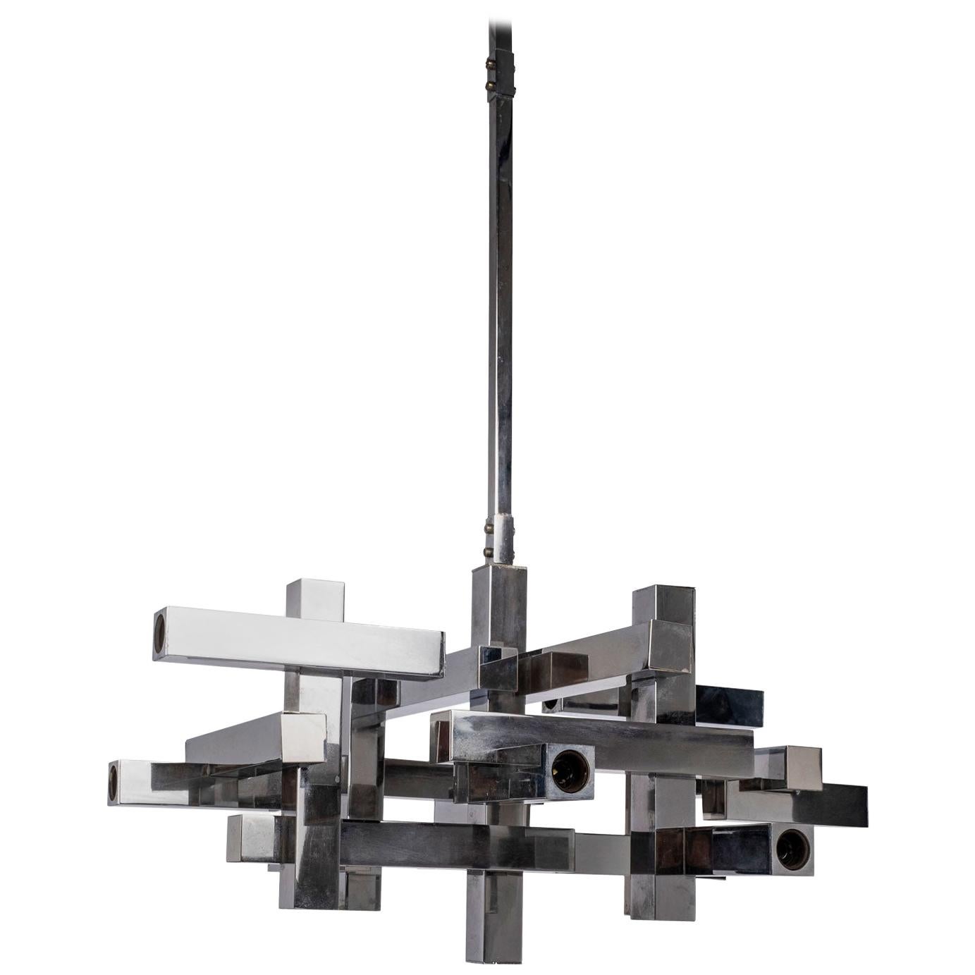 Large mid-century Gaetano Sciolari chrome cubic chandelier. This Italian modern chandelier features twelve candelabra-size sockets. Flushmount to ceiling, height can be adjusted within reason to accommodate your drop. Newly wired for use within the