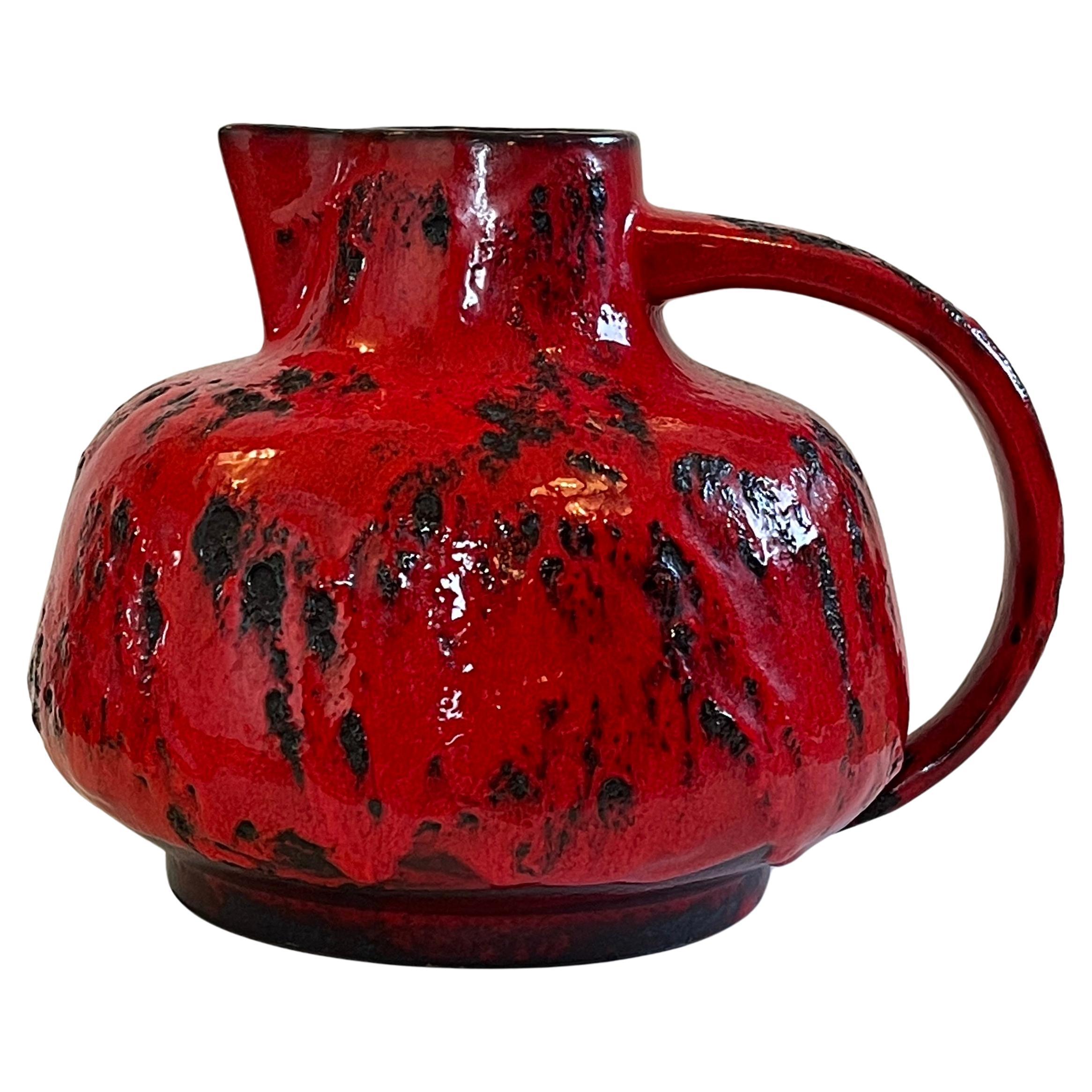 Expressive and very large German mid century modern handmade ceramic vase or jug in an impressive chunky and fiery red.
''Fat Lava'' ceramic at it's best by studio artist Ursula Beyrau for Graeflich Ortenburg, Germany.
Fantastic timeless shape