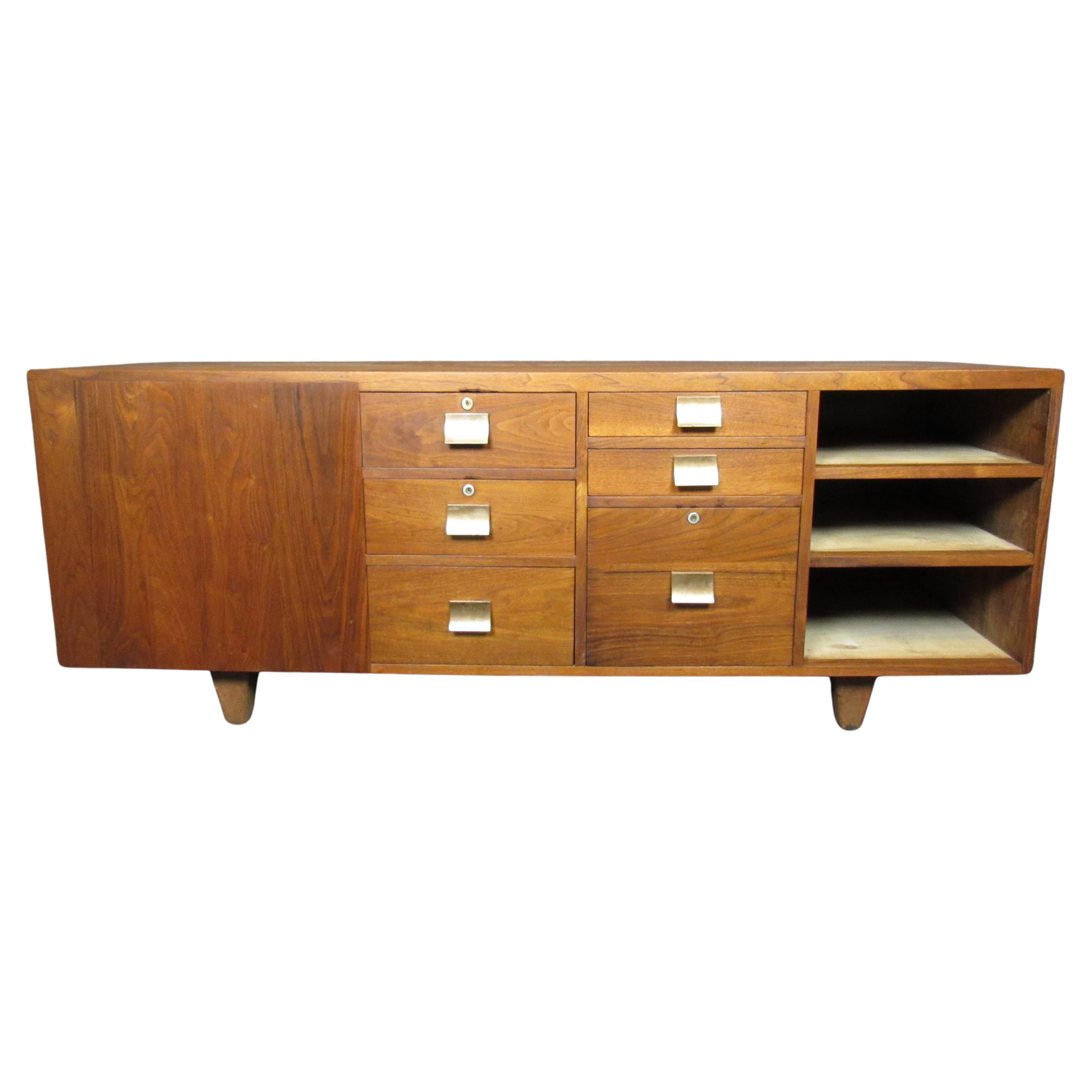 Very nice large-sized credenza sure to be a practical statement piece in your living space. Six large front drawers with three open shelves, as well as a deep side cabinet for ample storage and lots of organizational options. 
Please confirm item