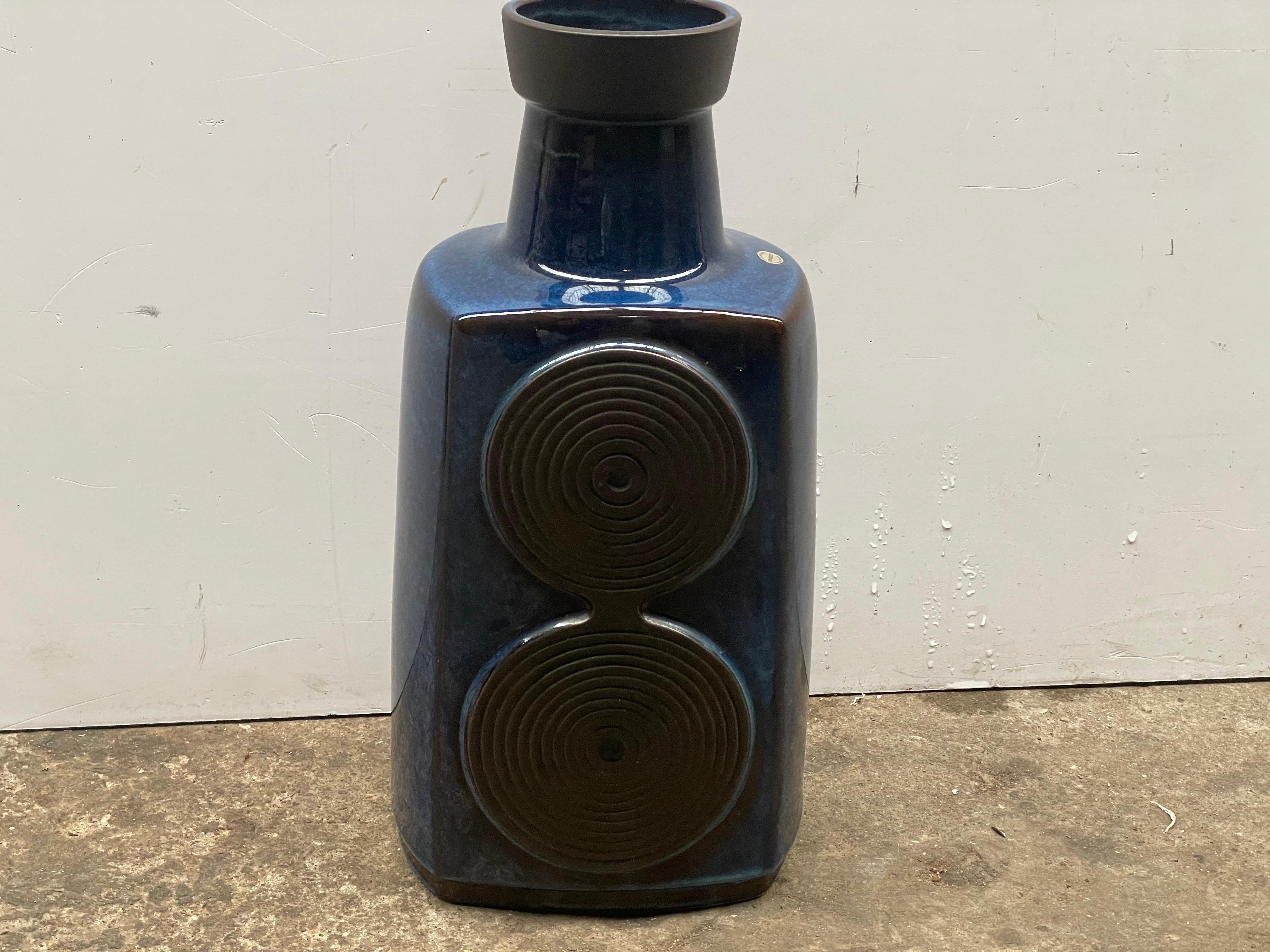 This striking blue ceramic floor vase, standing 42 cm tall, is a creation by Einar Johansen for Søholm Ceramics of Bornholm, Denmark. The piece exemplifies mid-century Scandinavian craftsmanship, blending clean geometric shapes with textured