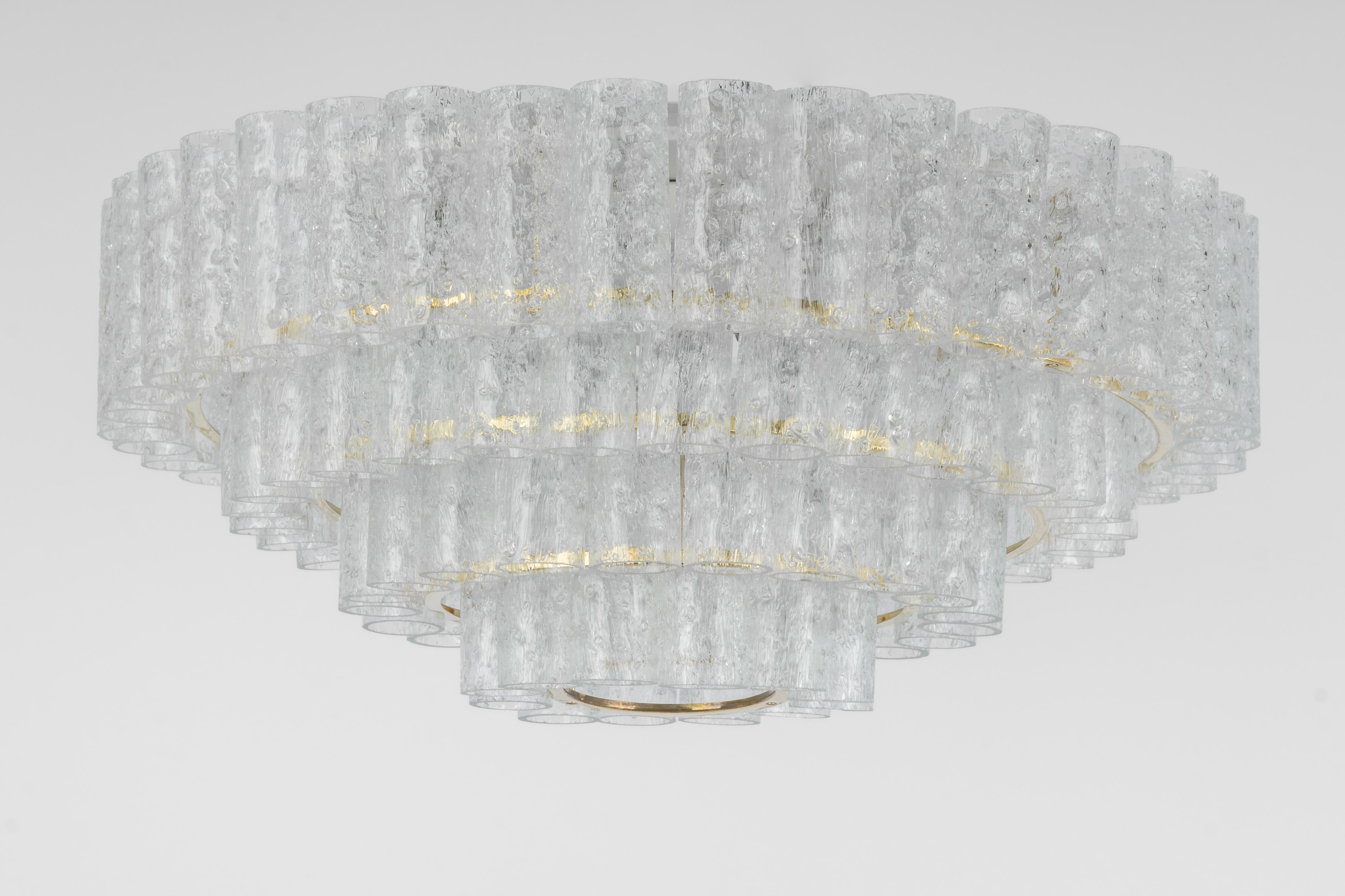 Fantastic four-tier midcentury chandelier by Doria, Germany, manufactured, circa 1960-1969. Four rings of Murano glass cylinders suspended from a fixture.
Heavy quality and in very good condition. Cleaned, well-wired and ready to use.
The fixture