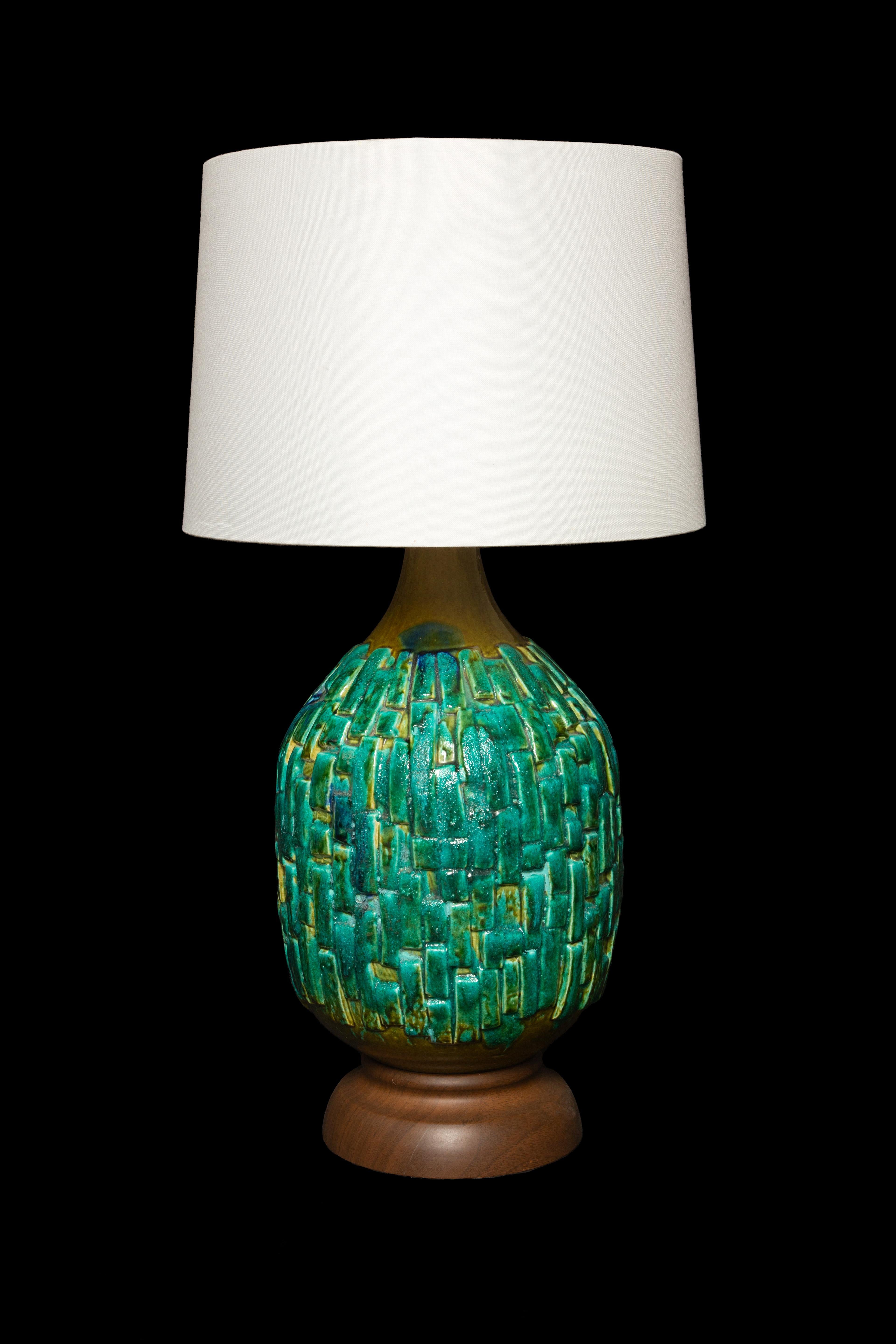 This Large Mid-Century Turquoise Ceramic Lamp is a beautiful and eye-catching addition to any room. Standing at a height of 34 inches, it has a commanding presence that draws attention. The rich Turquoise ceramic base adds a touch of sophistication