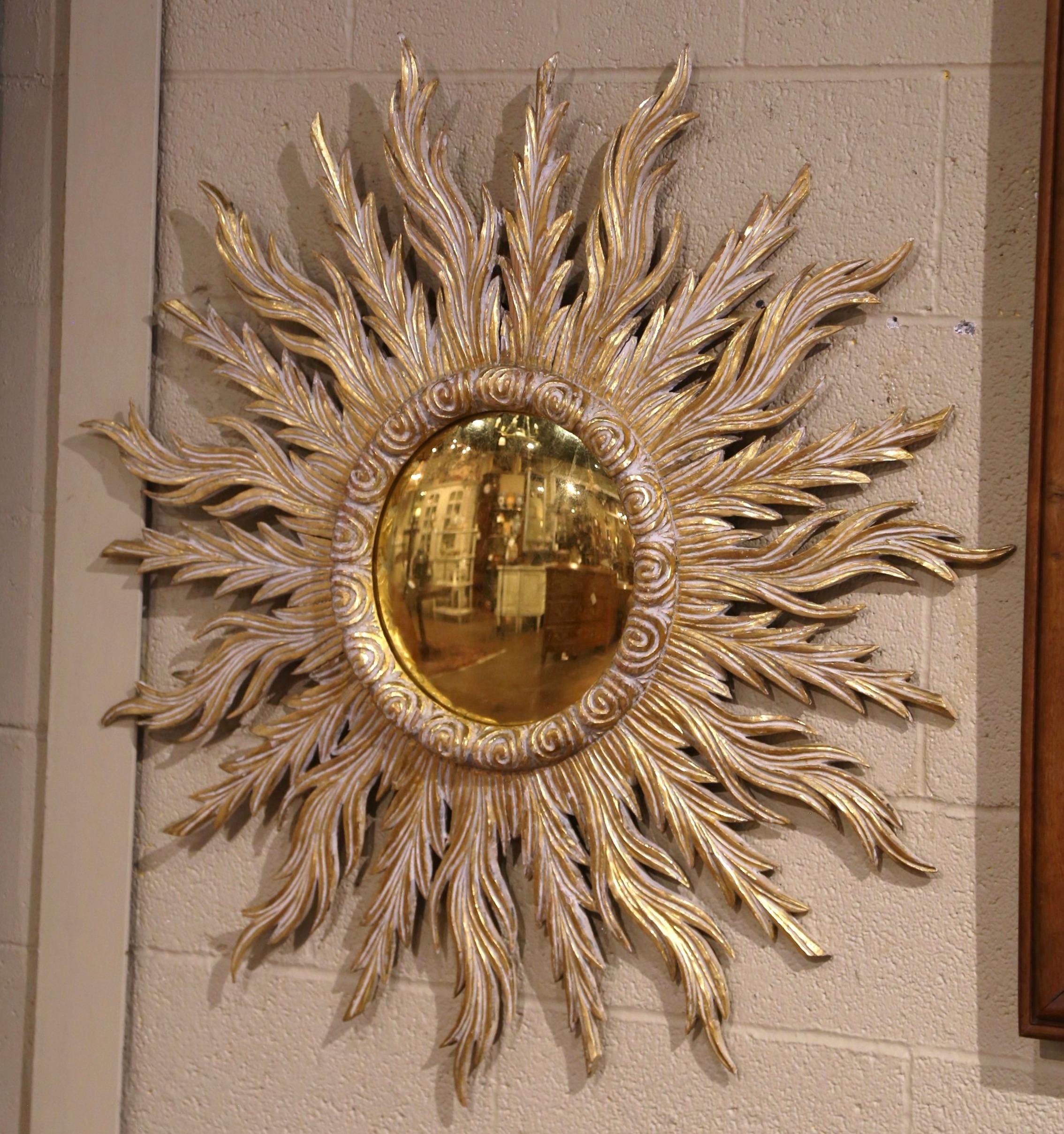 Add a beautiful shine to your home with this large eye-catching sun mirror. Hand carved in France circa 1970, the sunburst frame radiates with bold, stylized sun rays, rendered in gilded wood, giving the piece a luxurious and eye-catching presence.