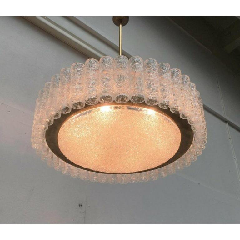 Imposant candlestick from the renowned manufacturer Doria Leuchten.

With almost 60 cm diameter and 41 glasses, this is one of Doria's large candlesticks. The elements of structural glass break and potentiate the light of the lamps inside. This