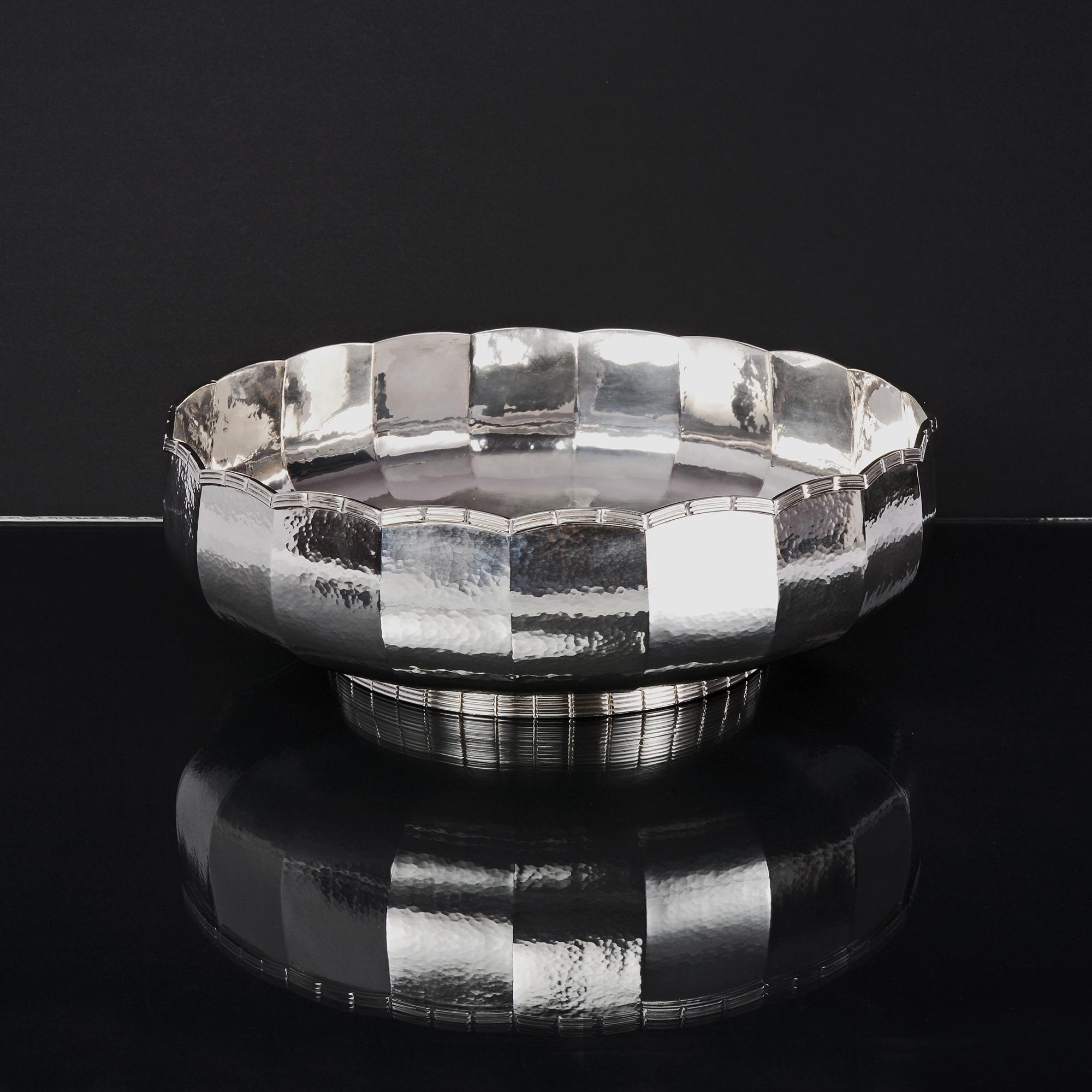 Really useful, large, decorative, mid-century-style handmade silver bowl, perfect as the centrepiece to a table or sideboard. Made by Asprey & Co, this hand-raised shallow and panelled bowl is hammered in a multi-faceted, stippled design and