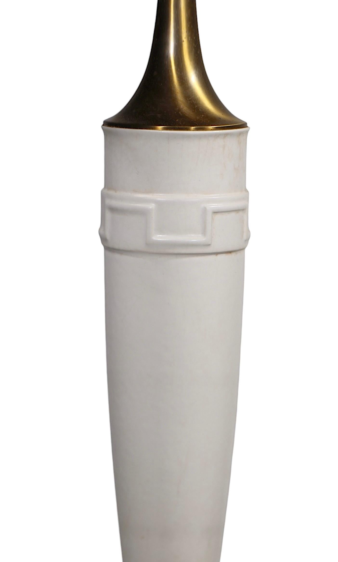 Exceptional oversize Mid Century Hollywood Regency table lamp, by the Rembrandt Lamp Company, circa 1950/60's. The lamp features an elongated ceramic body, with brass fittings, on a circular metal plinth form base. Included is the original  dramatic