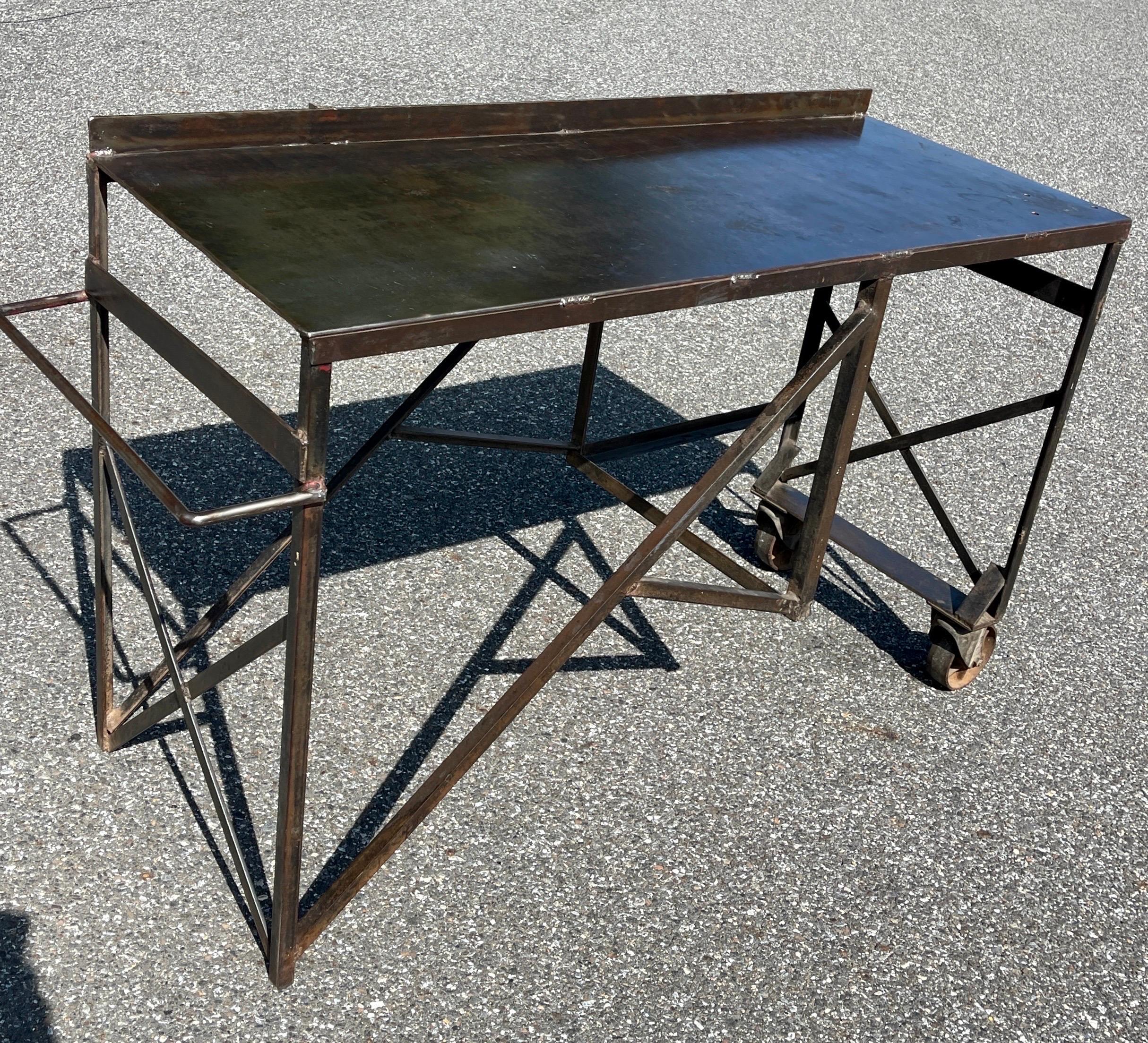 One of a Kind Industrial Work or Console Table, Mid-Century Modern 

Appealing and sturdy rolling work table on wheels. This vintage piece incorporates both form and function and is multifunctional as a work piece, desk, console piece suitable as a