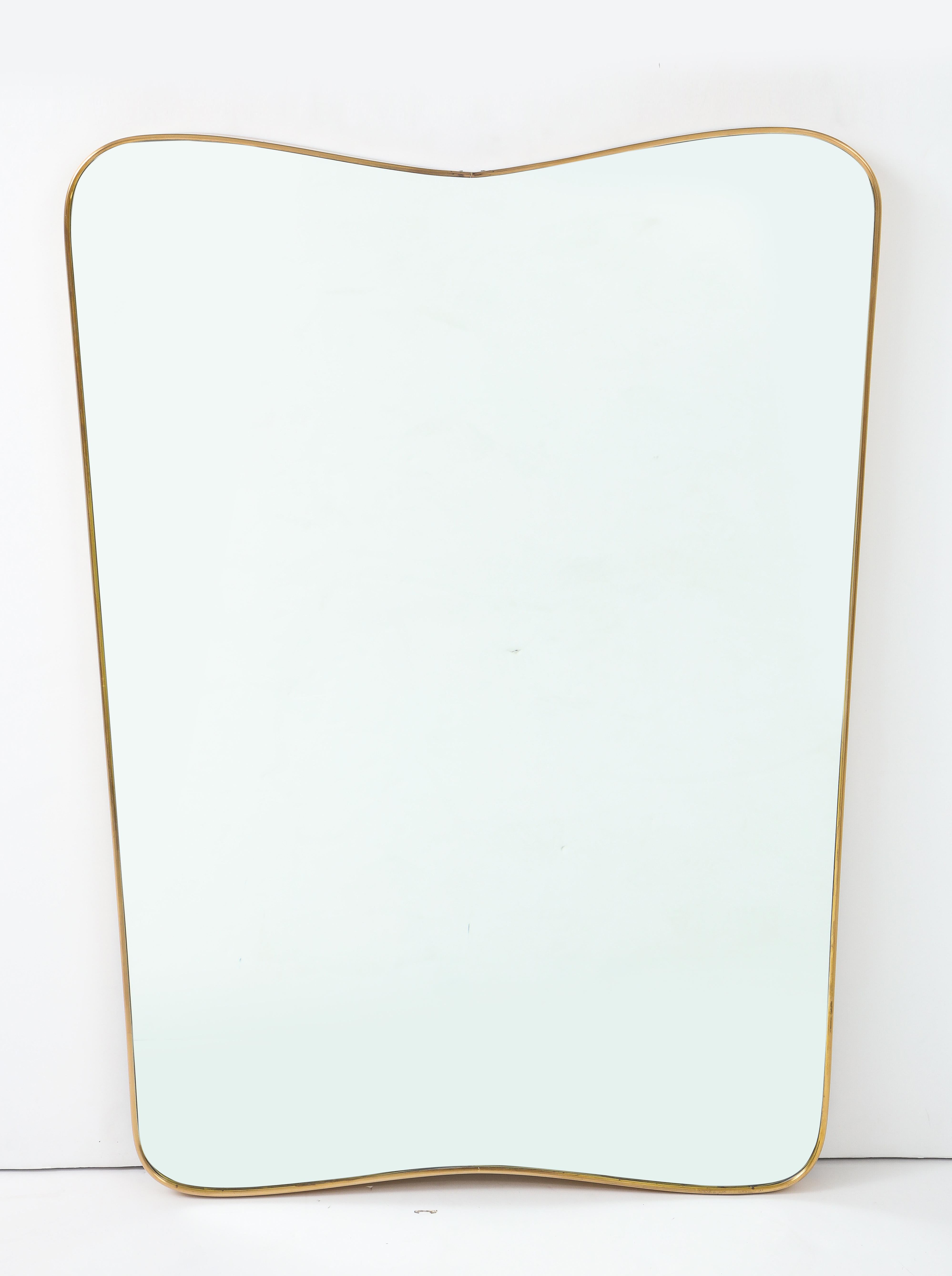 This midcentury Italian solid un-lacquered brass mirror carries a more unique modified shield shape form and is its depth is much deeper than those seen in general lending a bolder more substantial presence. It’s solid wood back is original.
Date: