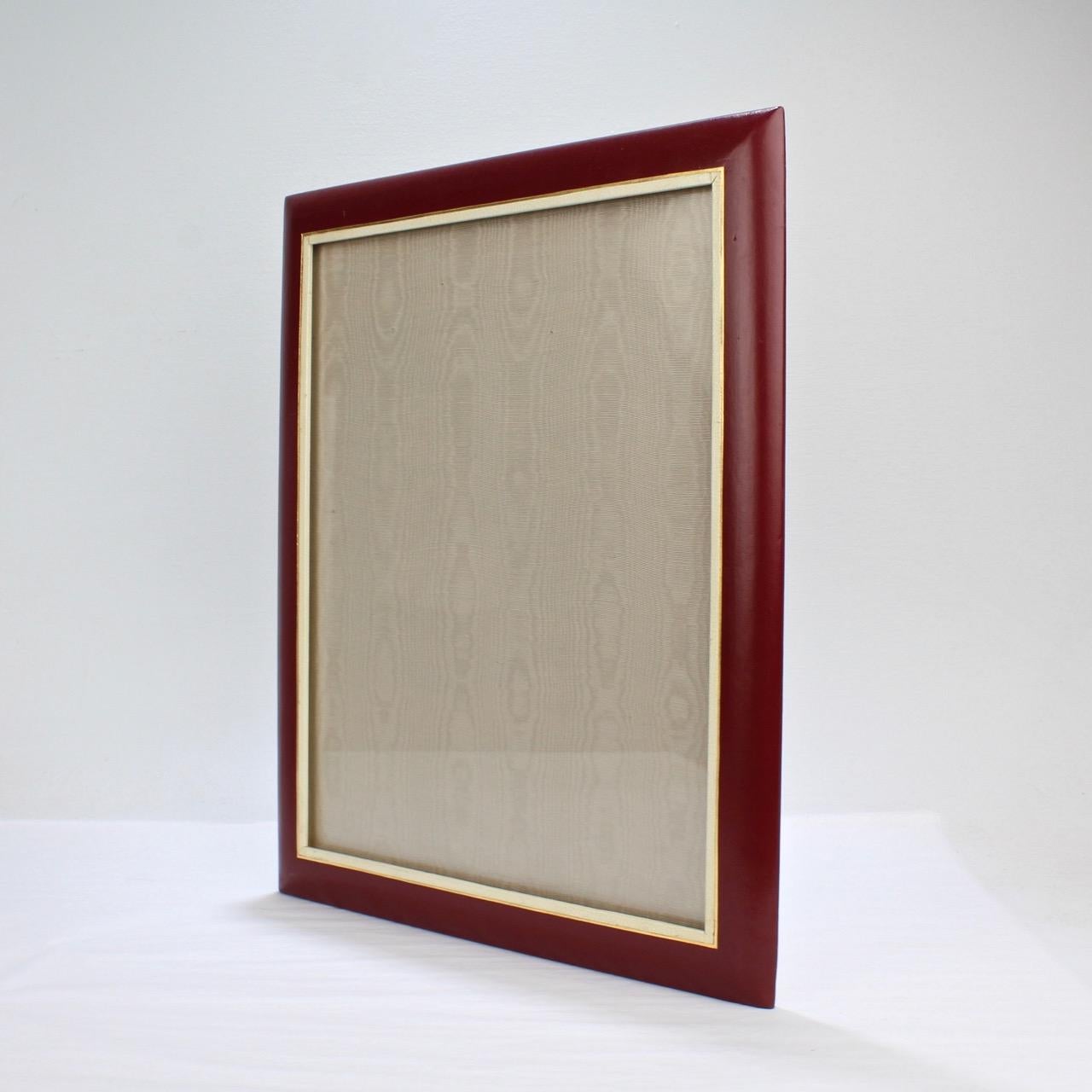 A fine Italian midcentury picture frame.

With a burgundy border, white and gold color interior border, and an easel back.

Perfect for the large format photo!

The reverse marked: Cross Italy leather.

Measures: Height ca. 16 in
Width ca.