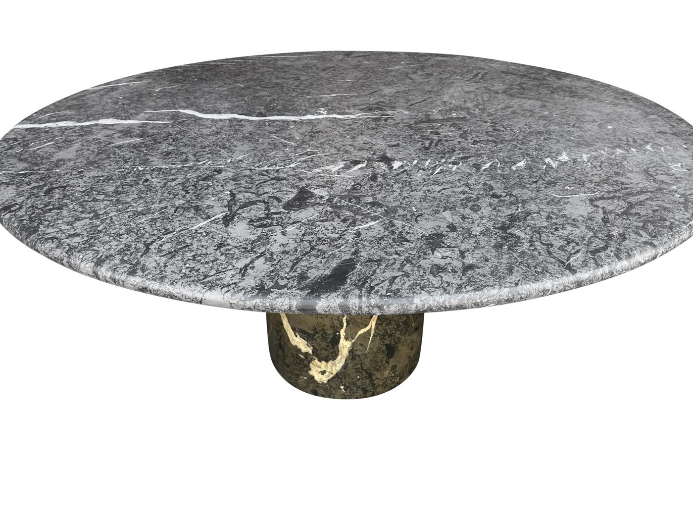 A stunning and substantial round dining table in two color marble combination. It features a thick circular base with large almost 60 inch top. Well take care of and ready for use.
