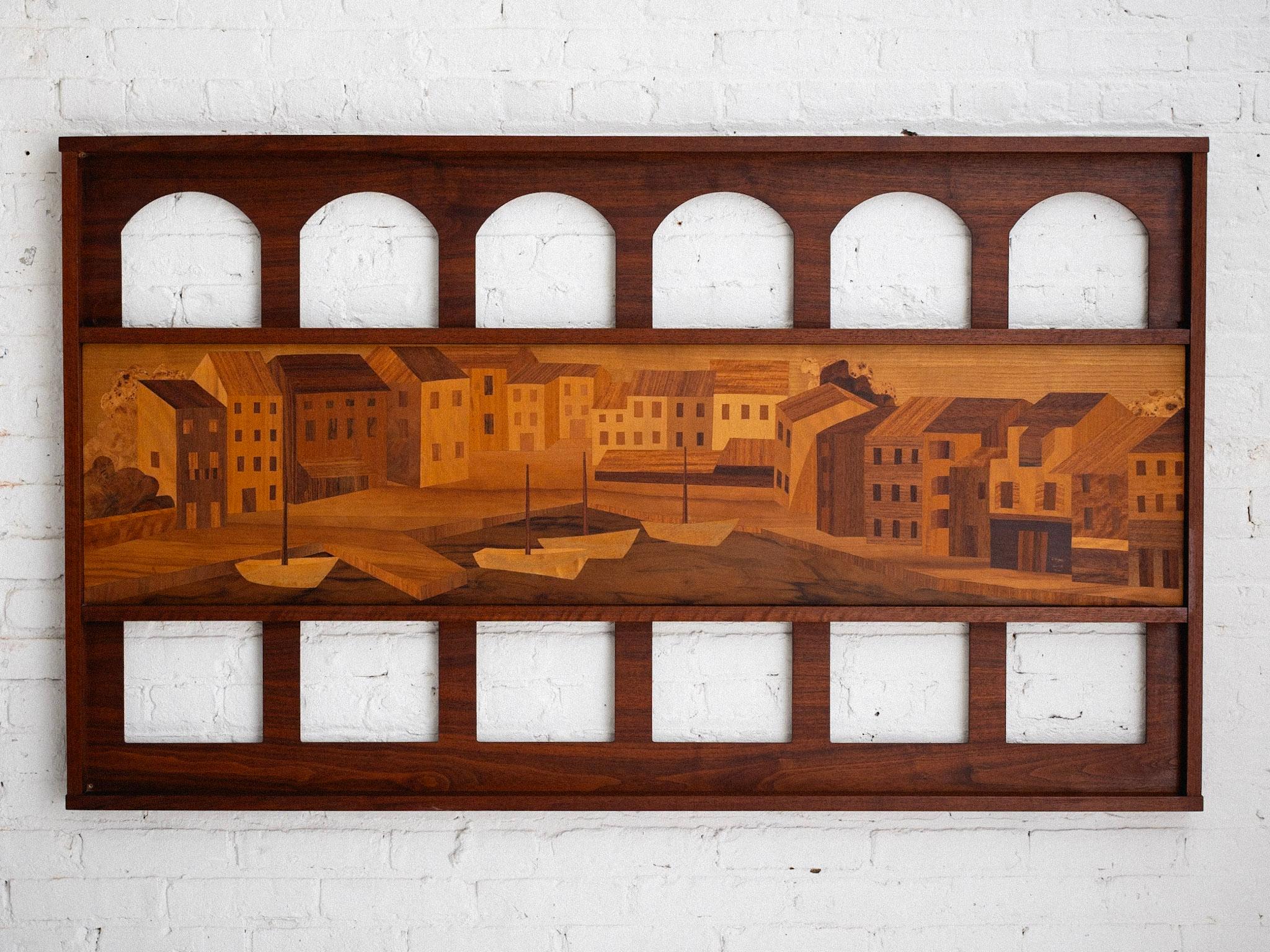 A mid century Italian wood marquetry art panel. Composed of a scenic depiction of an Italian seaside village and sculptural arches. Rich warm color scheme from the different wood inlays used.