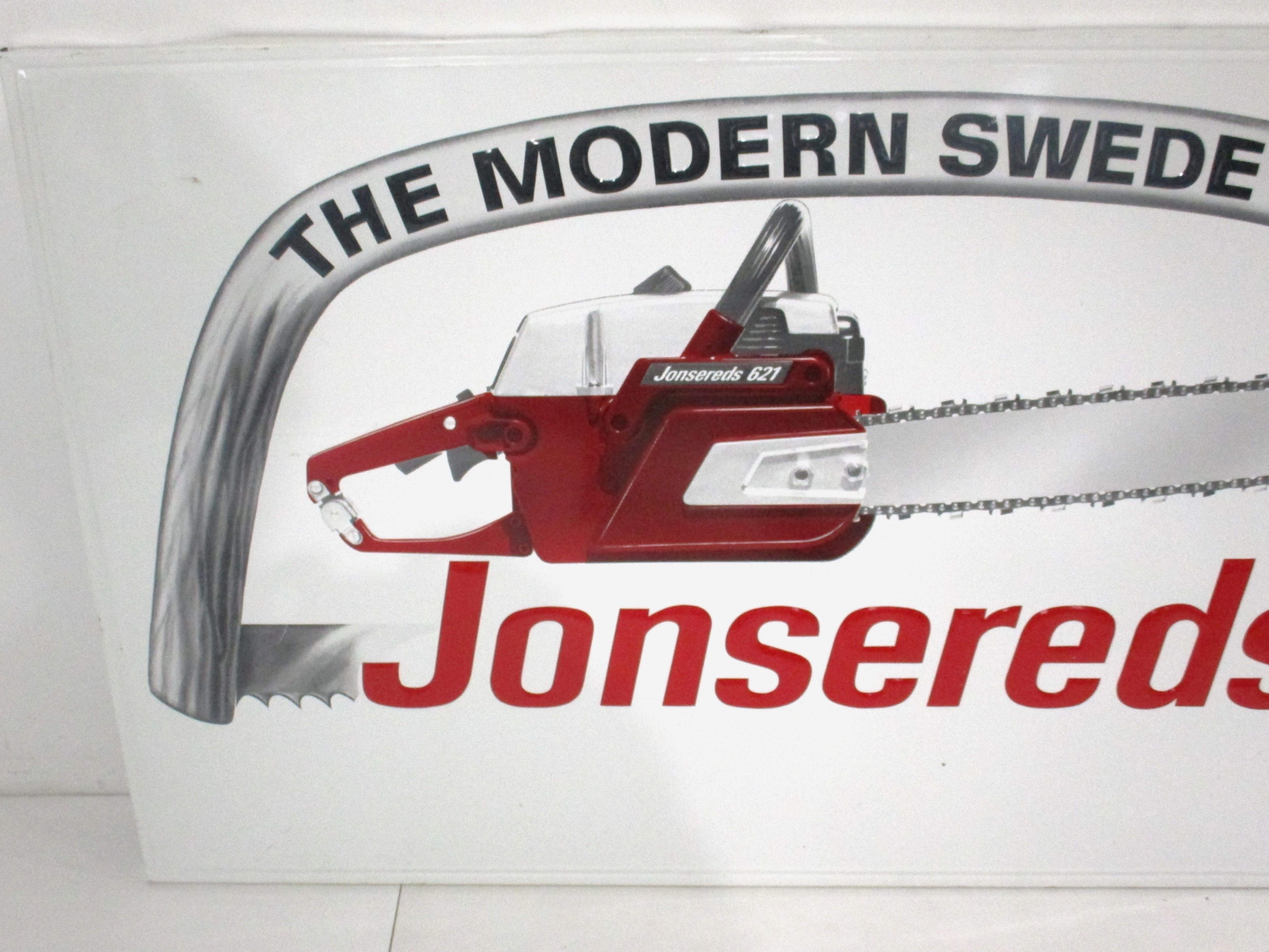 A large embossed and printed metal advertising sign for the Jonsereds chain saw company . The company makers of the traditional Swedish styled hand saw as depicted on the sign shown with their newest chain saw model number 621 titled 