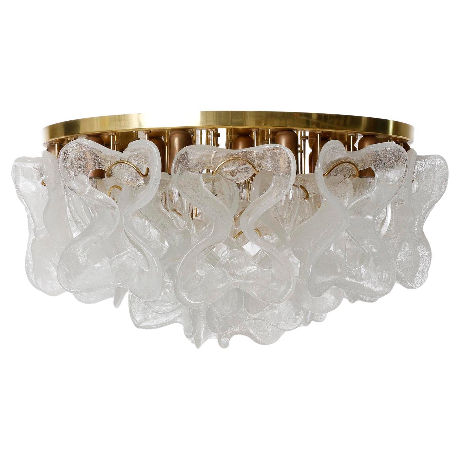 An extra large and fantastic Mid-Century modern light fixture model 'Catena' by J.T. Kalmar, Austria, manufatured in 1970s-1980s. 
It consists of a polished brass plate with patinated bulb socket covers and 30 organic and ribbon-shaped bubble Murano